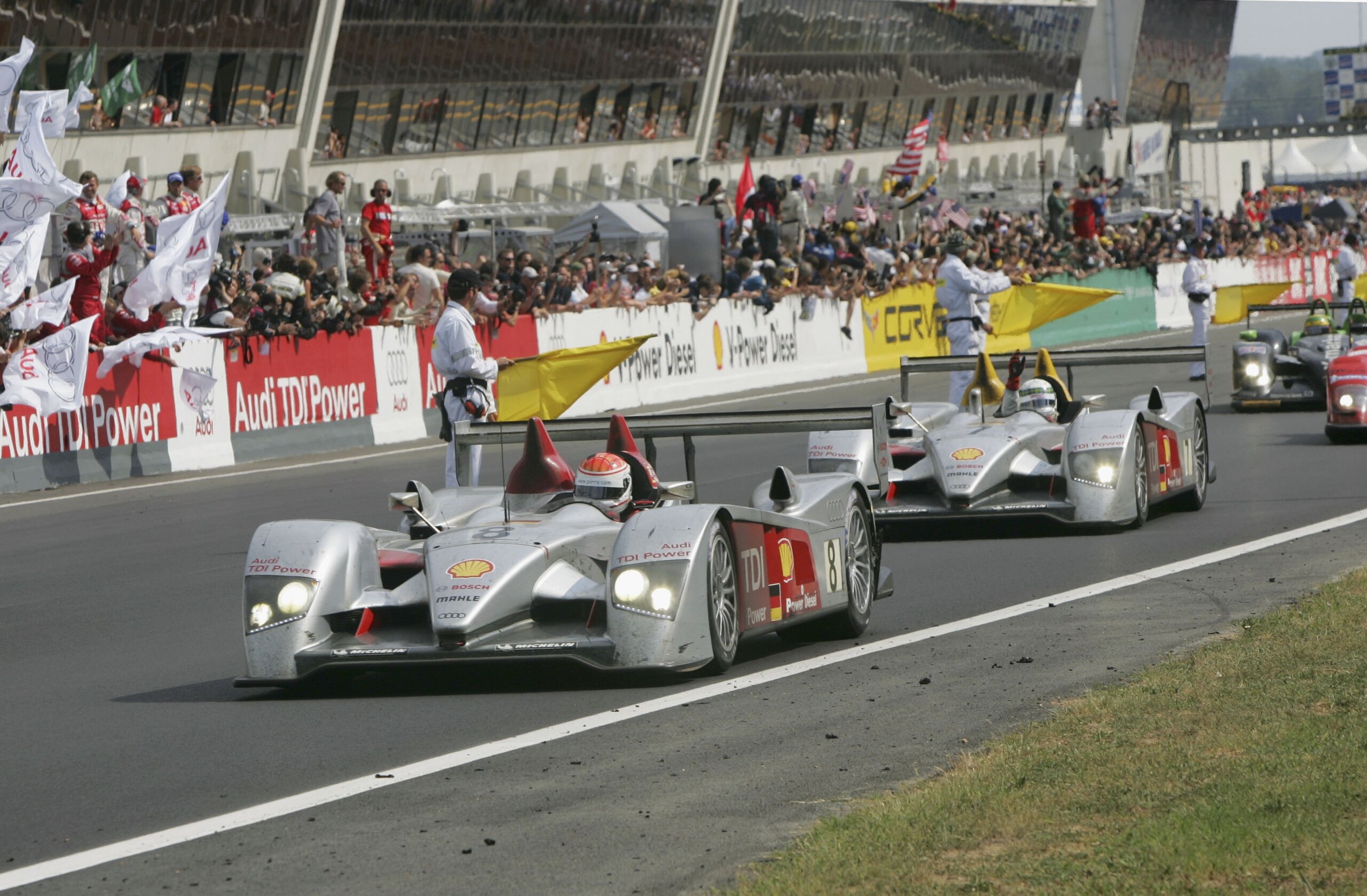 LE MANS, FRANCE - JUNE 18: Emanuele Pirro and Allan McNish finish 1st and 3rd after 24 hours of racing at the end of the Le Mans 24H Race at the Le Mans Sarthe Circuit on June 18, 2006 in Le Mans, France. (Photo by John Marsh/Getty Images) LE MANS, FRANCE - JUNE 18: Emanuele Pirro and Allan McNish finish 1st and 3rd after 24 hours of racing at the end of the Le Mans 24H Race at the Le Mans Sarthe Circuit on June 18, 2006 in Le Mans, France. (Photo by John Marsh/Getty Images)