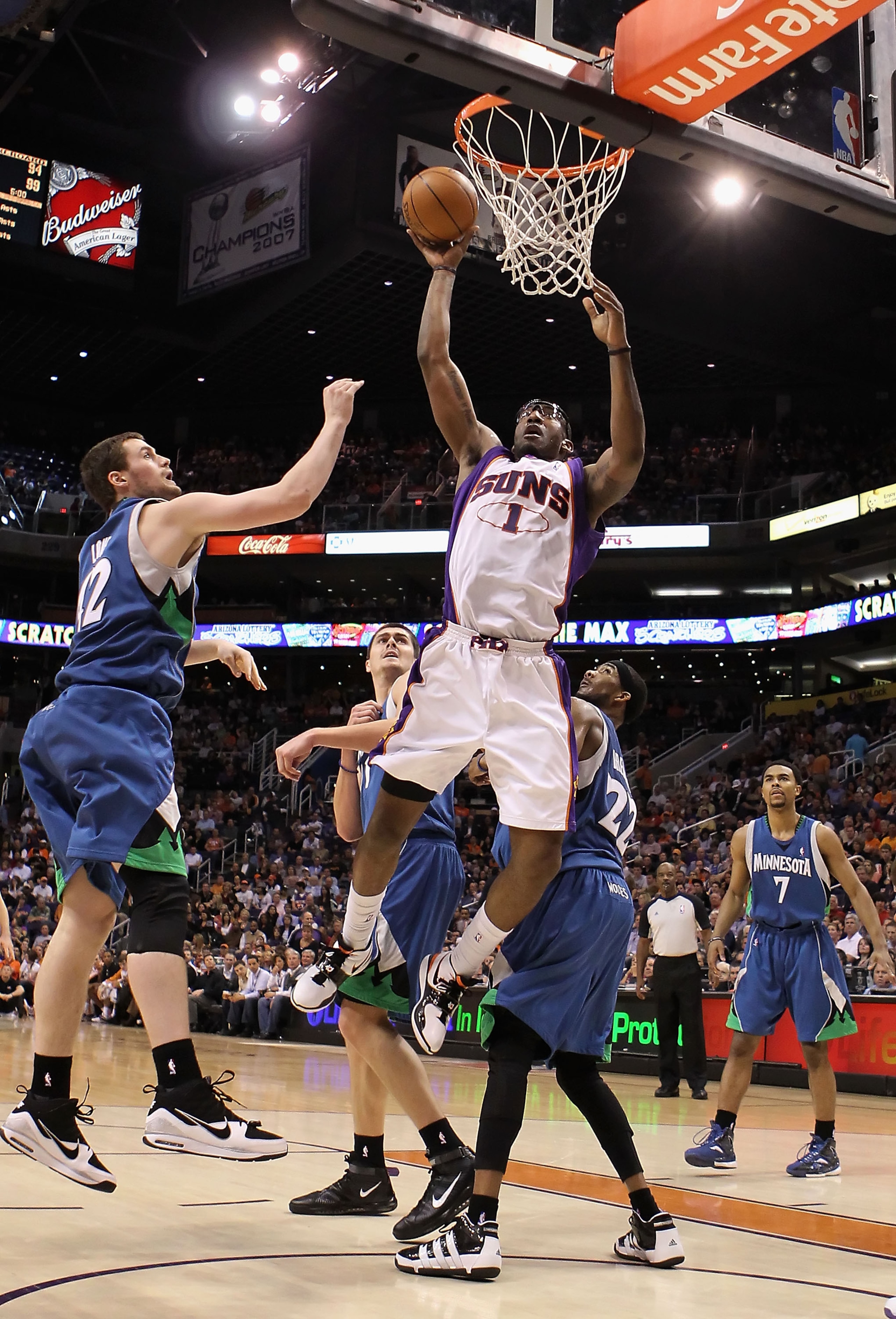 PHOENIX - MARCH 16:  Amar'e Stoudemire #1 of the Phoenix Suns puts up a shot past Kevin Love #42 of the Minnesota Timberwolves during the NBA game at US Airways Center on March 16, 2010 in Phoenix, Arizona. The Suns defeated the Timberwolves 152-114.  NOT