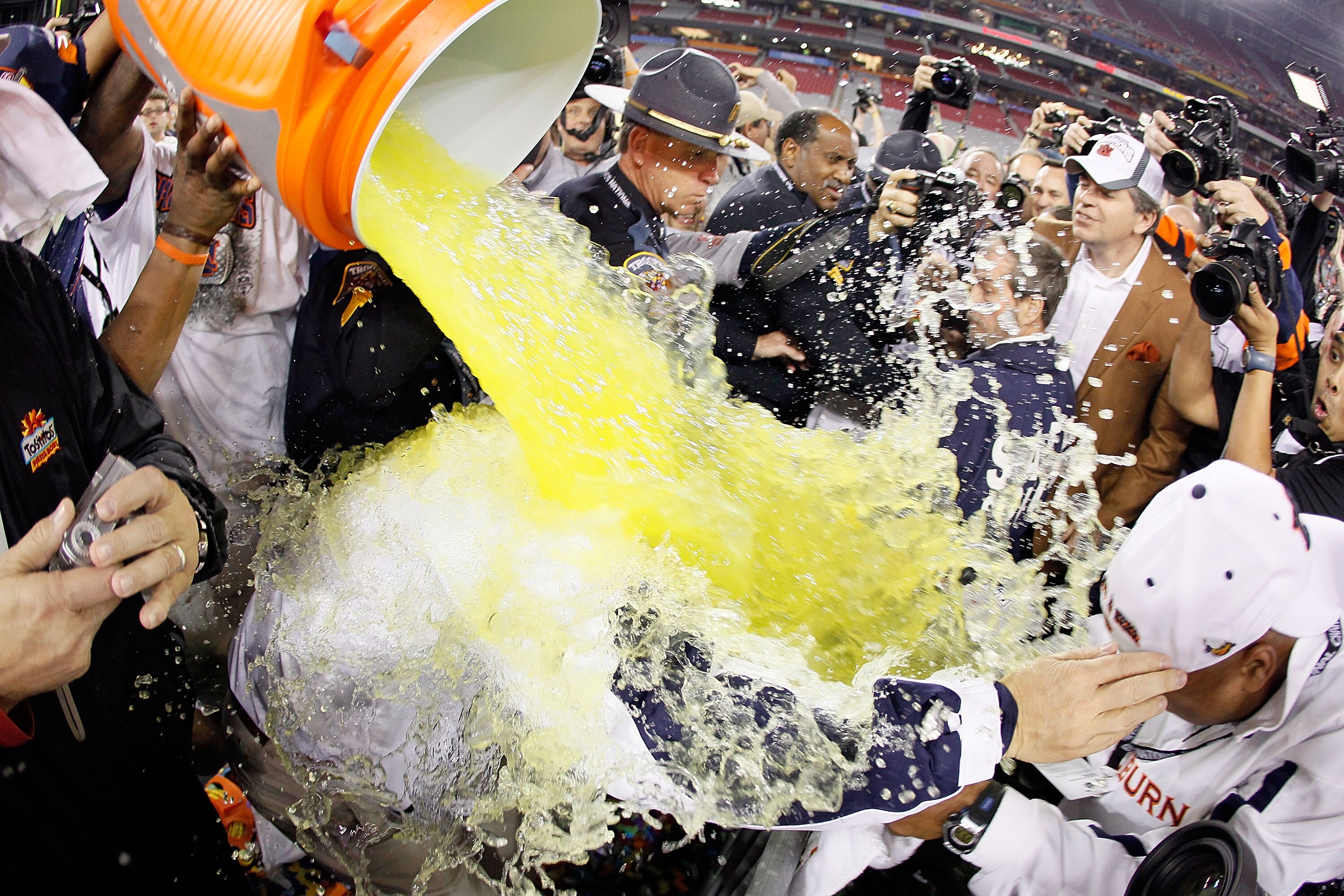 GLENDALE, AZ - JANUARY 10:  Quarterback Cameron Newton #2 of the Auburn Tigers dumps gatorade on head coach Gene Chizik as they celebrate the Tigers 22-19 victory with the fans after defeating the Oregon Ducks in the Tostitos BCS National Championship Gam