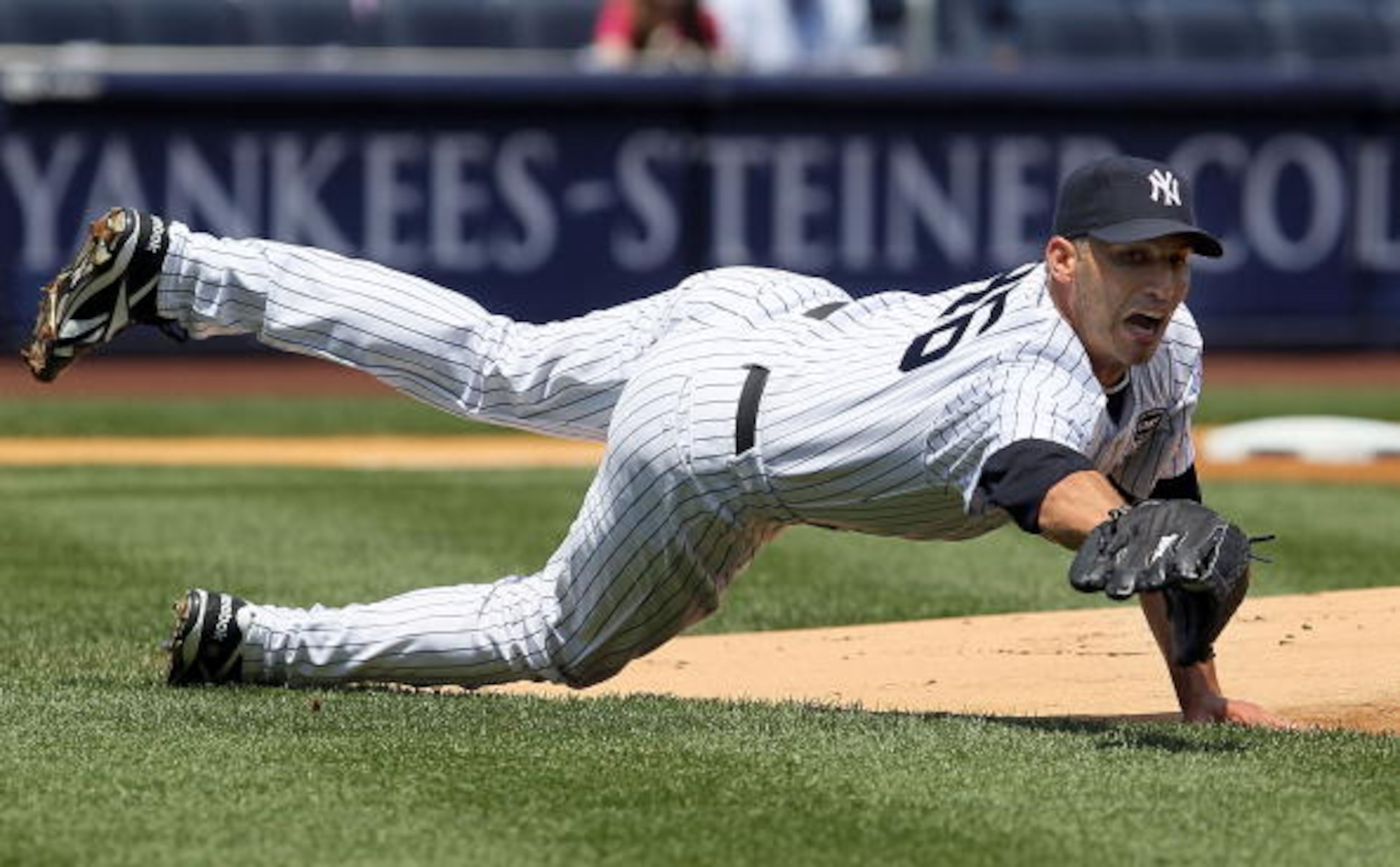 NEW YORK - JULY 18:  Andy Pettitte #46 of the New York Yankees fields a ball bunted by Carl Crawfor (not pictured) of the Tampa Bay Rays during the first inning on July 18, 2010 at Yankee Stadium in the Bronx borough of New York City.  (Photo by Jim McIsa