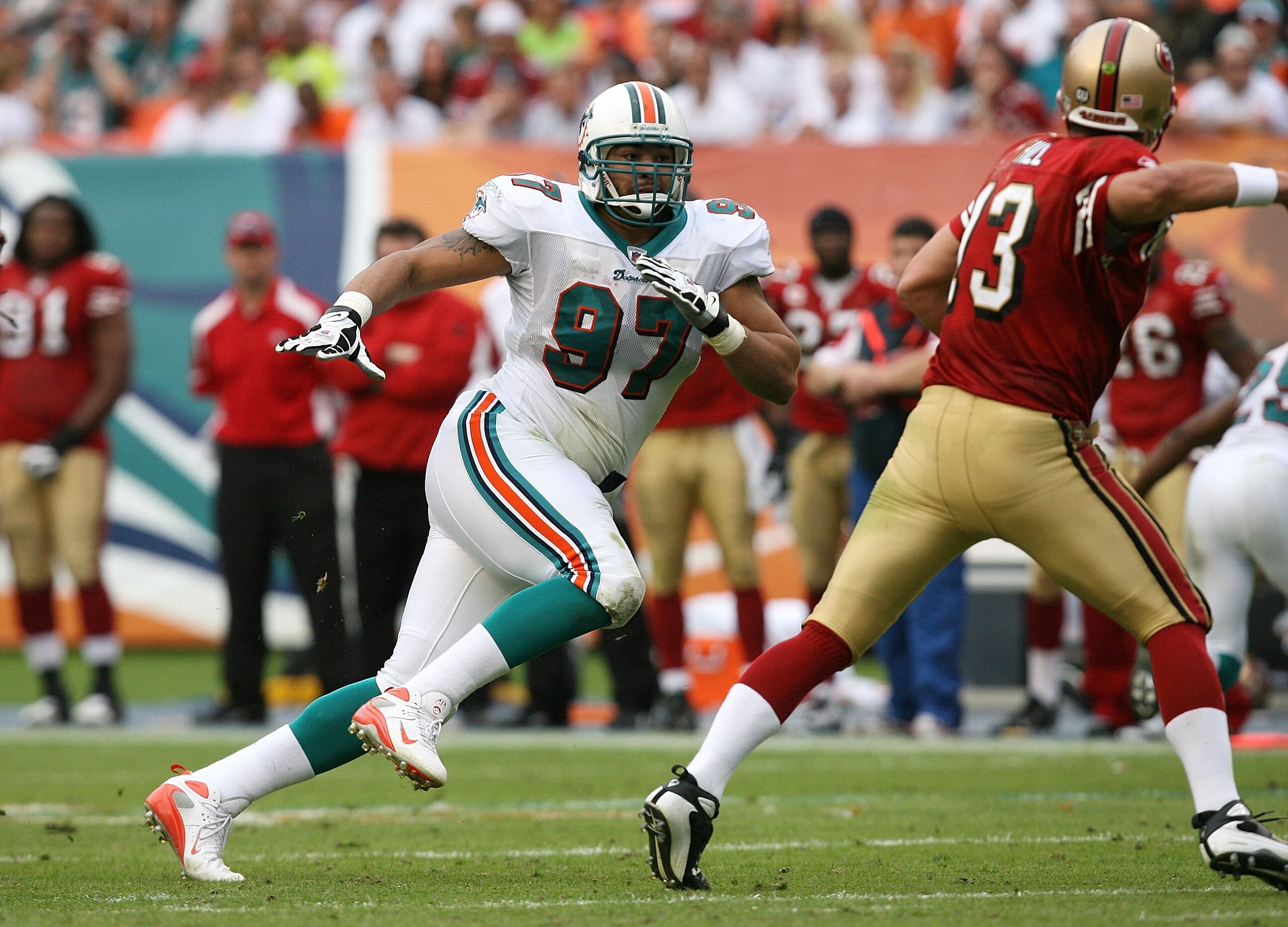 MIAMI - DECEMBER 14:  Defensive end Phillip Merling #97 of the Miami Dolphins chases quarterback Shaun Hill #13 of the San Francisco 49ers at Dolphin Stadium on December 14, 2008 in Miami, Florida. The Dolphins defeated the 49ers 14-9.  (Photo by Doug Ben