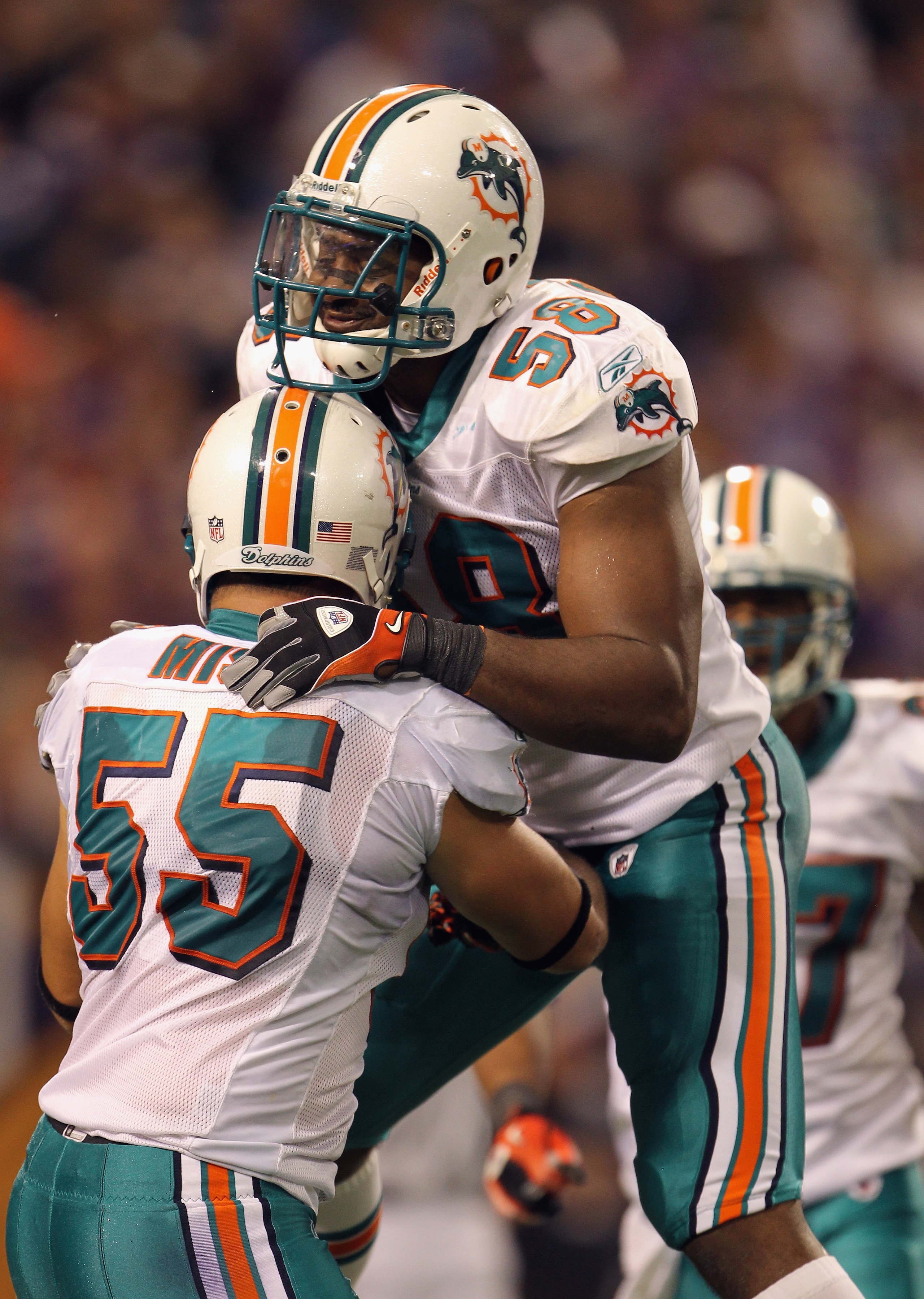 MINNEAPOLIS - SEPTEMBER 19:  Karlos Dansby #58 of the Miami Dolphins celebrates with Koa Misi #55 after the Dolphins defense recovered a fumble in the end zone for a touchdown during the game against the Minnesota Vikings on September 19, 2010 at Hubert H