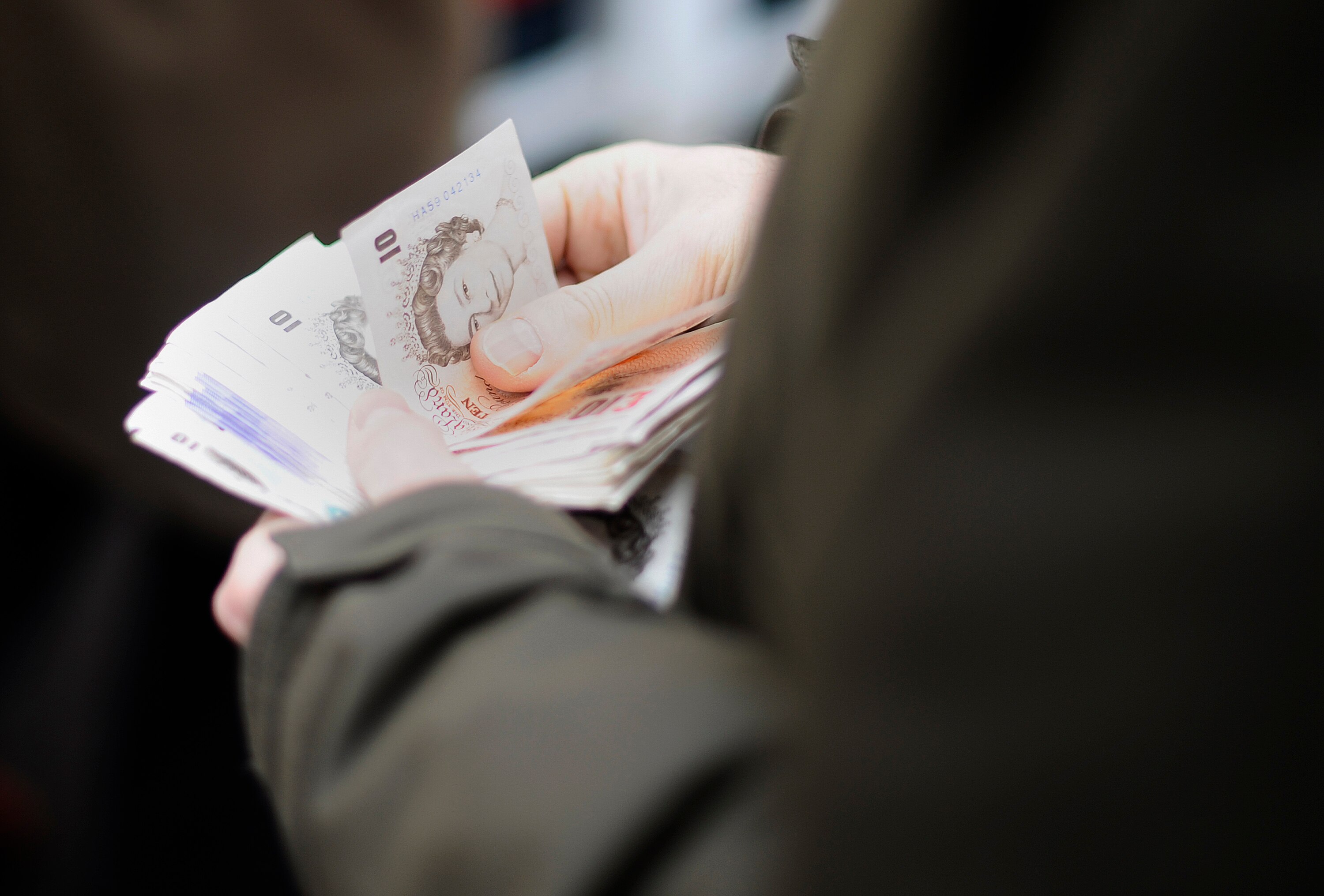 NEWBURY, ENGLAND - DECEMBER 15:  A punter gets his money ready for a wager at Newbury racecourse on December 15, 2010 in Newbury, England.  (Photo by Alan Crowhurst/ Getty Images)