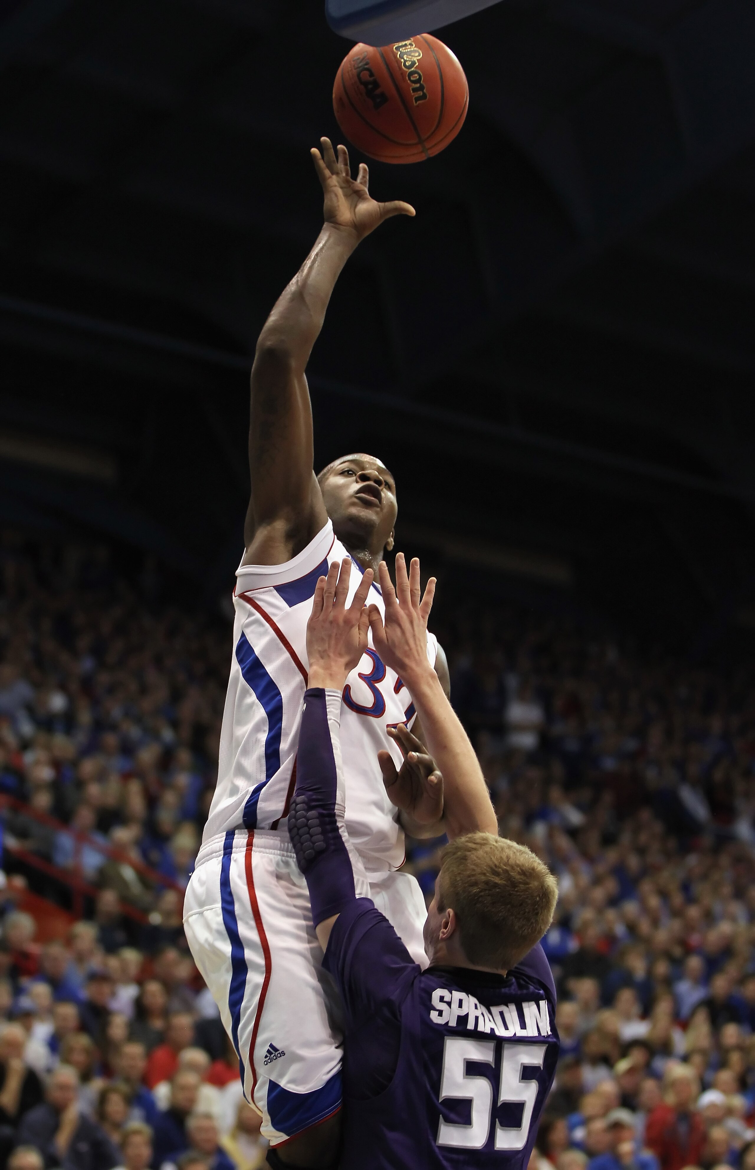 LAWRENCE, KS - JANUARY 29:  Josh Selby #32 of the Kansas Jayhawks shoots over Will Spradling #55 of the Kansas State Wildcats during the game on January 29, 2011 at Allen Fieldhouse in Lawrence, Kansas.  (Photo by Jamie Squire/Getty Images)