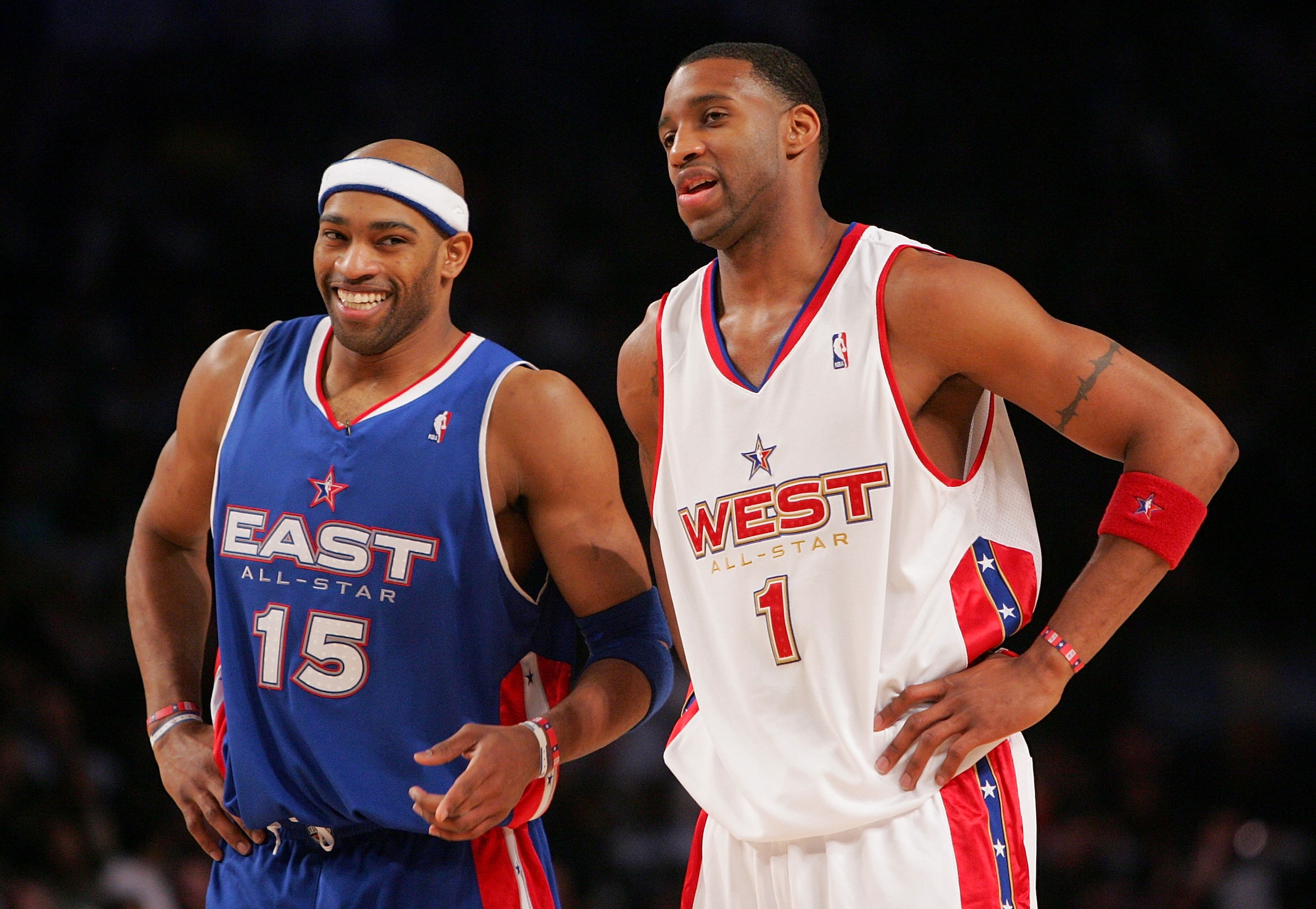 DENVER - FEBRUARY 20:   Vince Carter #15 of the Eastern Conference All-Stars laughs with Tracy McGrady #1 of the Western Conference All-Stars during the 54th All-Star Game, part of 2005 NBA All-Star Weekend at Pepsi Center on February 20, 2005 in Denver, 