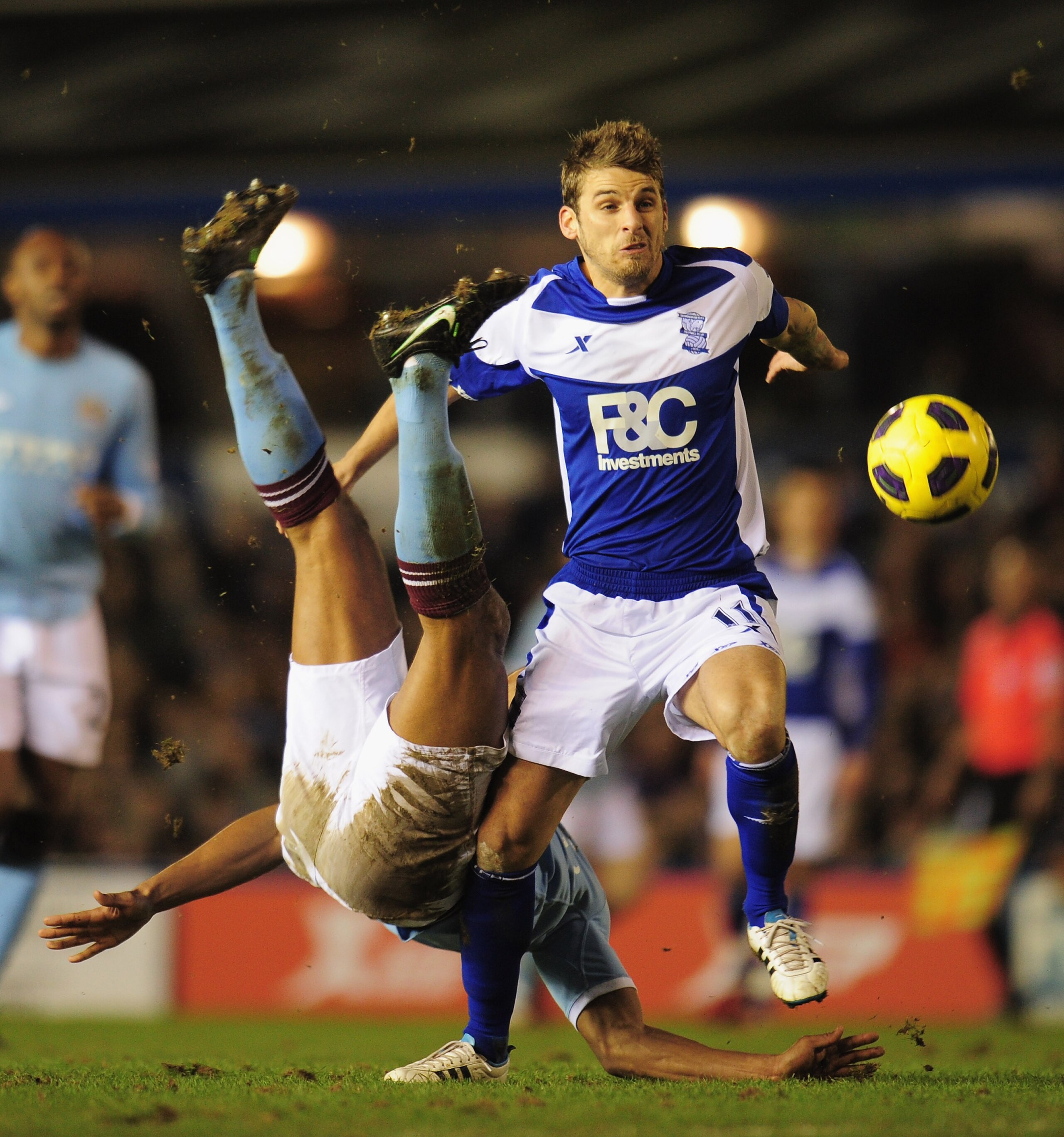 BIRMINGHAM, ENGLAND - FEBRUARY 02:  David Bentley of Birmingham City is challenged by Vincent Kompany of Manchester City during the Barclays Premier League match between Birmingham City and Manchester City at St. Andrews on February 2, 2011 in Birmingham,