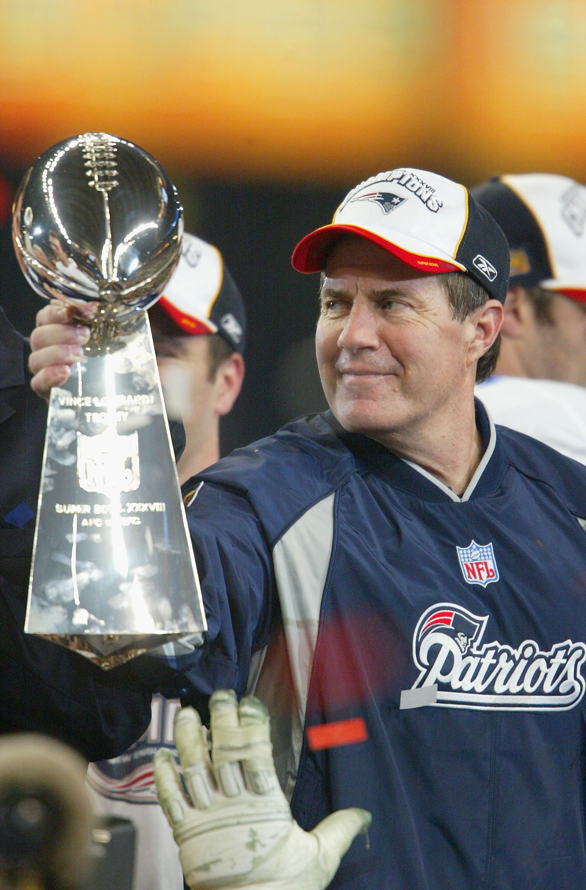 HOUSTON, TX - FEBRUARY 1:  Head coach Bill Belichick of the New England Patriots holds the Lombardi trophy after defeating the Carolina Panthers 32-29 in Super Bowl XXXVIII at Reliant Stadium on February 1, 2004 in Houston, Texas. (Photo by Andy Lyons/Get