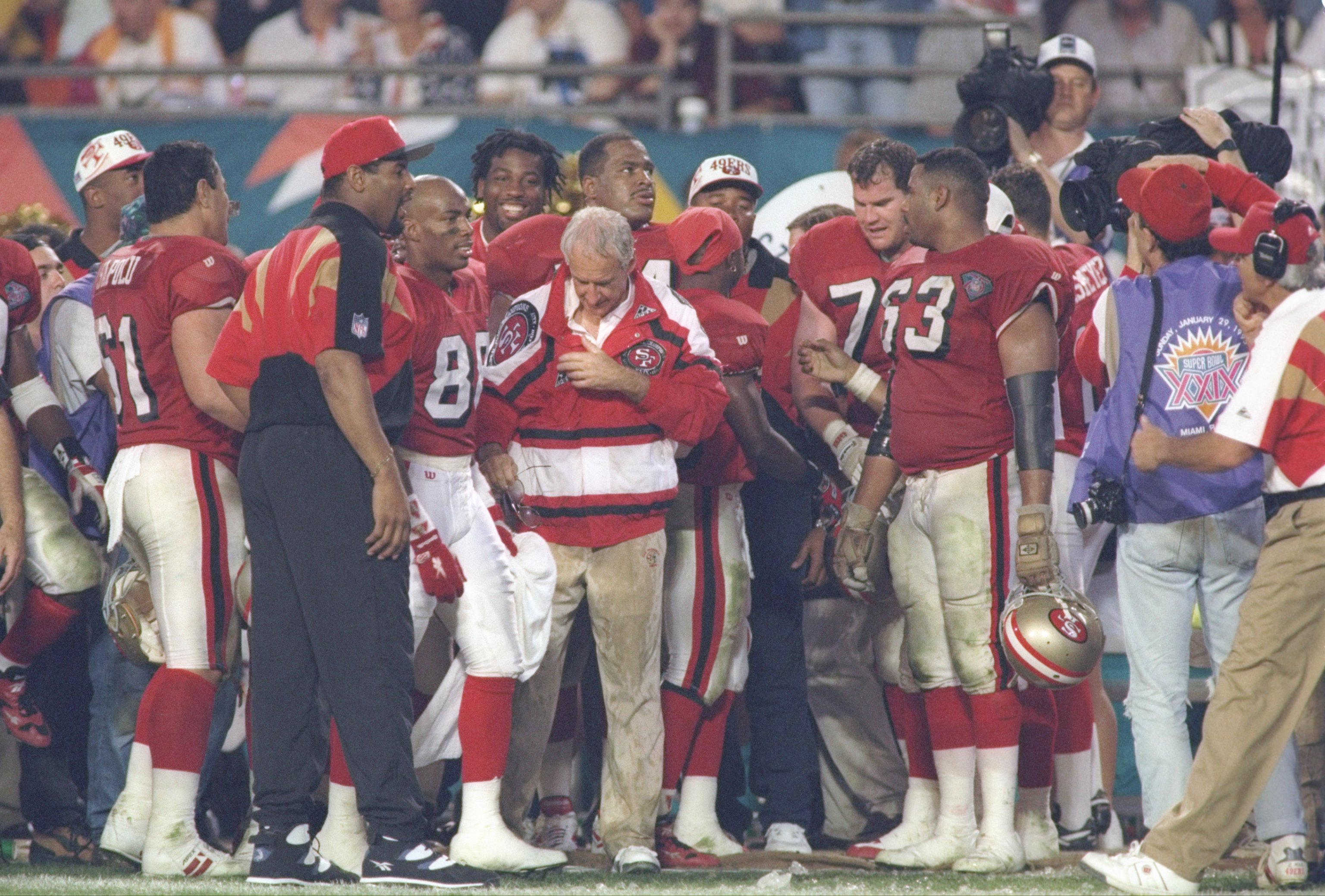 29 Jan 1995:  Head coach George Seifert (center) of the San Francisco 49ers pauses during fourth quarter of Super Bowl XXIX against the San Diego Chargers at Joe Robbie Stadium in Miami, Florida.  The 49ers won 49-26.     Mandatory Credit: Rick Stewart  /