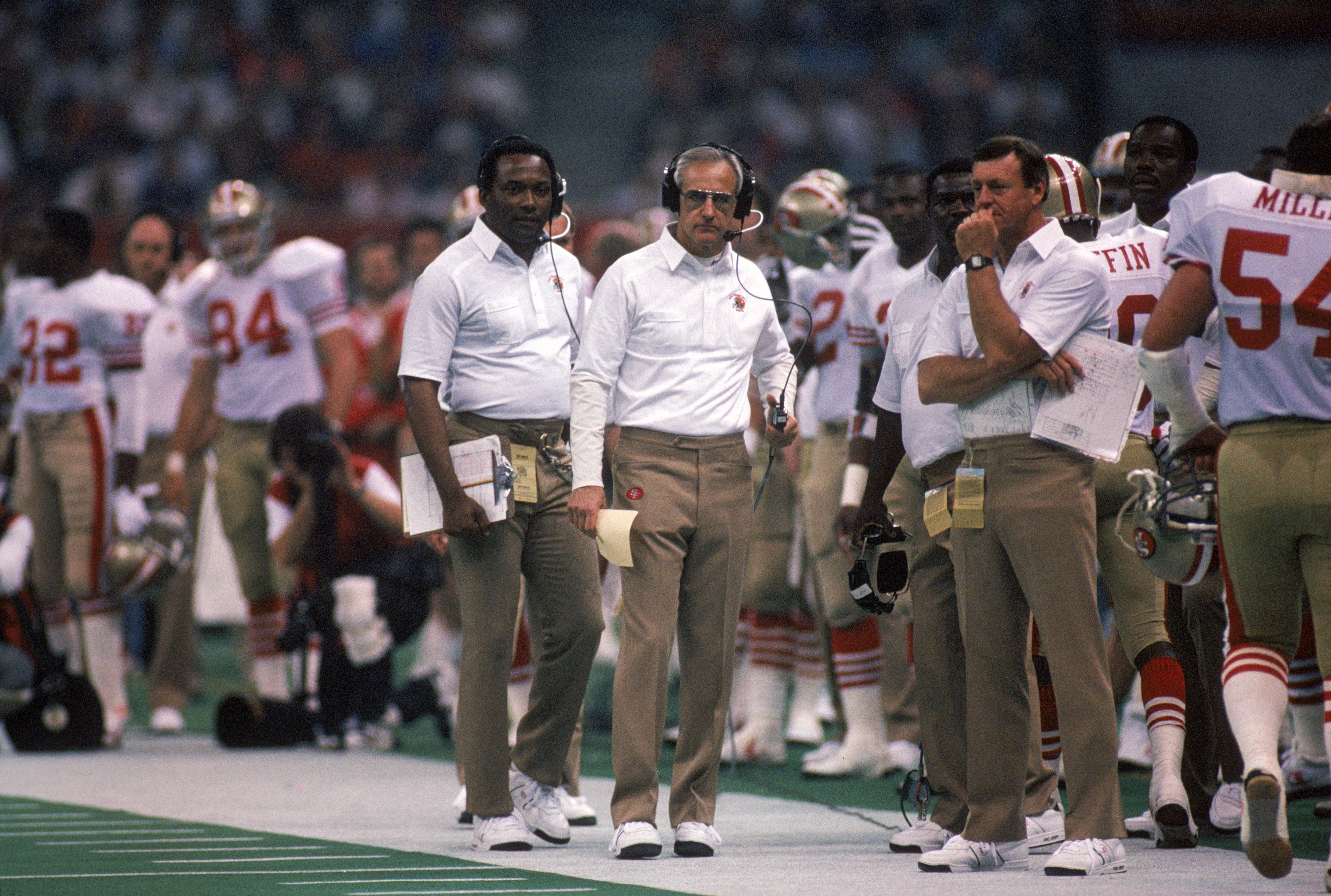 NEW ORLEANS - JANUARY 28:  Head coach George Seifert of the San Francisco 49ers and his coaching staff stands on the sideline in Super Bowl XXIV against the Denver Broncos at Louisiana Superdome on January 28, 1990 in New Orleans, Louisiana.  The 49ers wo