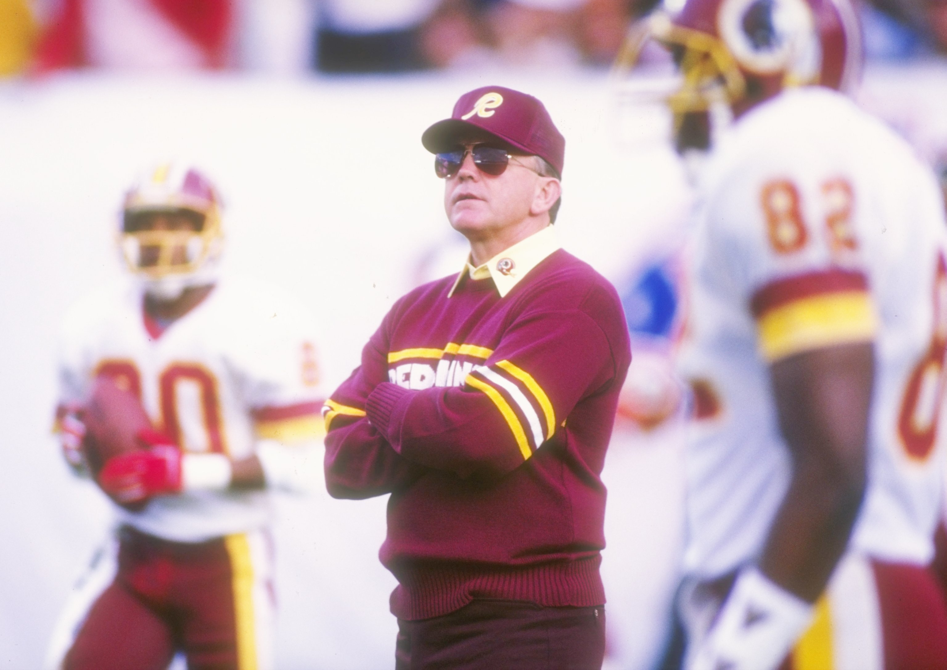 31 Jan 1988:  Joe Gibbs, head coach of the Washington Redskins, (center) watches the game closely during Super Bowl XXII against the Denver Broncos at  Jack Murphy Stadium in San Diego, California.  The Redskins won 42-10. Mandatory Credit: Stephen Dunn