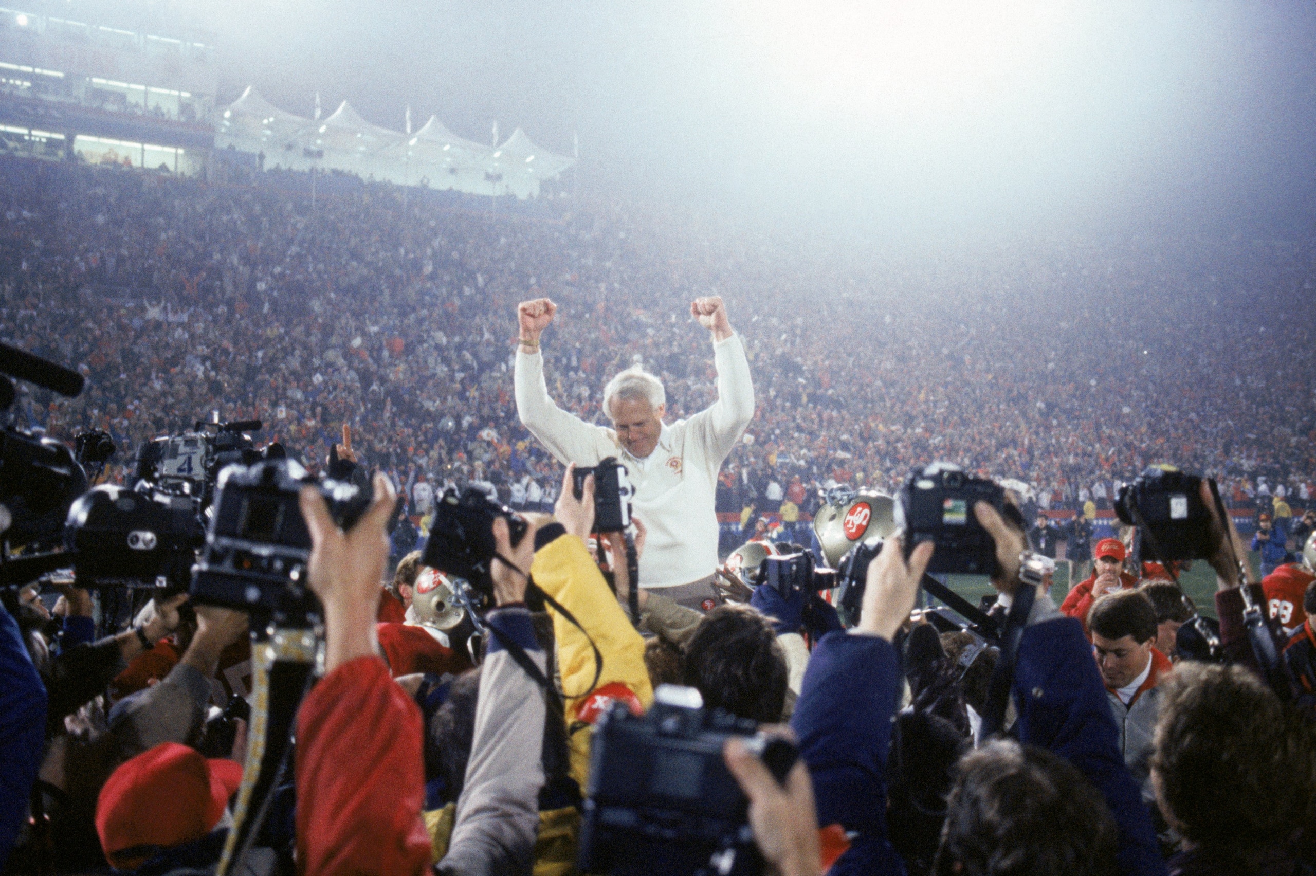STANFORD, CA - JANUARY 20:  Head coach Bill Walsh of the San Francisco 49ers enjoys a victory ride on the field after defeating the Miami Dolphins 38-16 in Super Bowl XIX at Stanford Stadium on January 20, 1985 in Stanford, California.  (Photo by George R