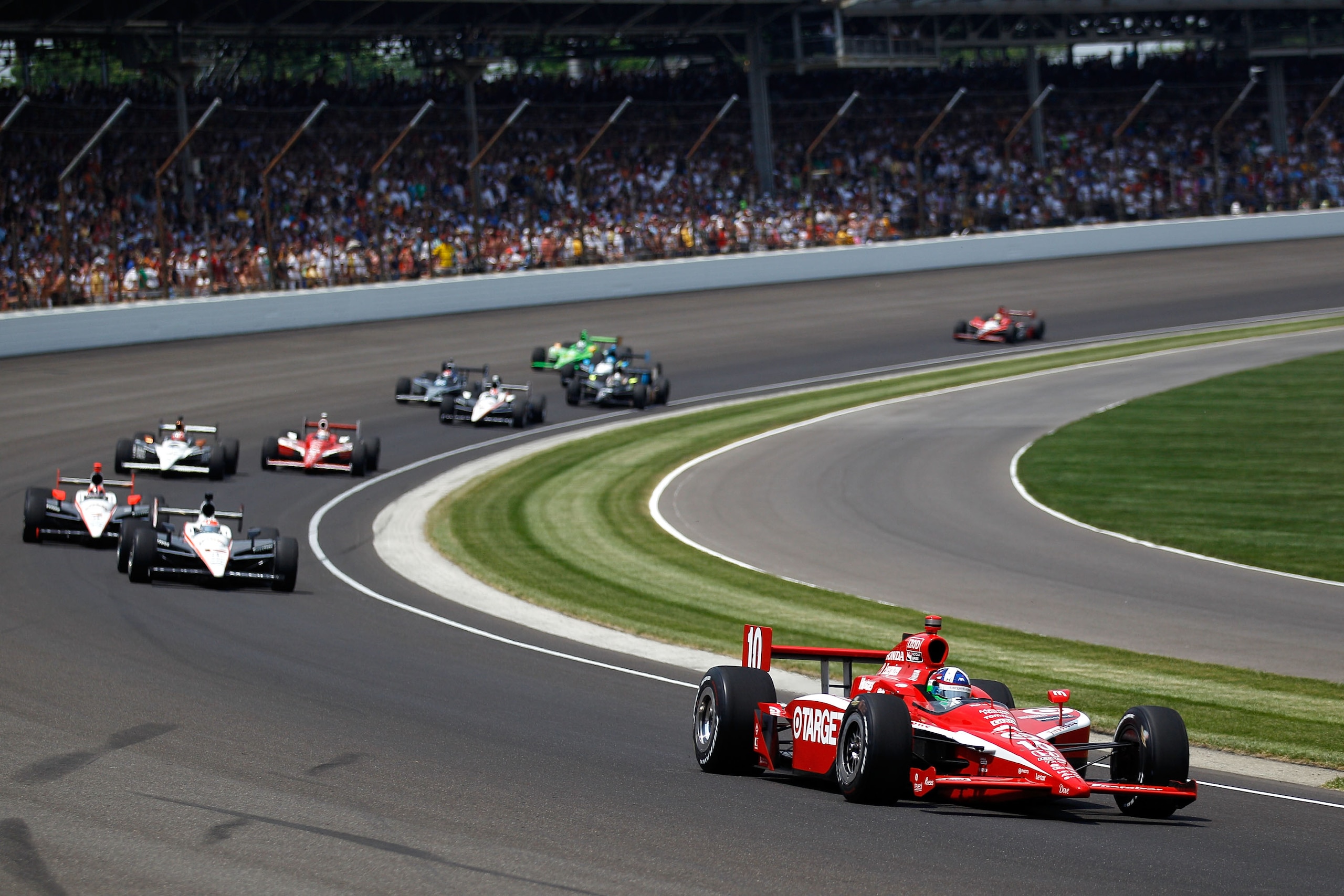 INDIANAPOLIS - MAY 30: Dario Franchitti of Scotland, driver of the #10 Target Chip Ganassi Racing Dallara Honda, leads a pack of cars through turn one during the IZOD IndyCar Series 94th running of the Indianapolis 500 at the Indianapolis Motor Speedway INDIANAPOLIS - MAY 30: Dario Franchitti of Scotland, driver of the #10 Target Chip Ganassi Racing Dallara Honda, leads a pack of cars through turn one during the IZOD IndyCar Series 94th running of the Indianapolis 500 at the Indianapolis Motor Speedway