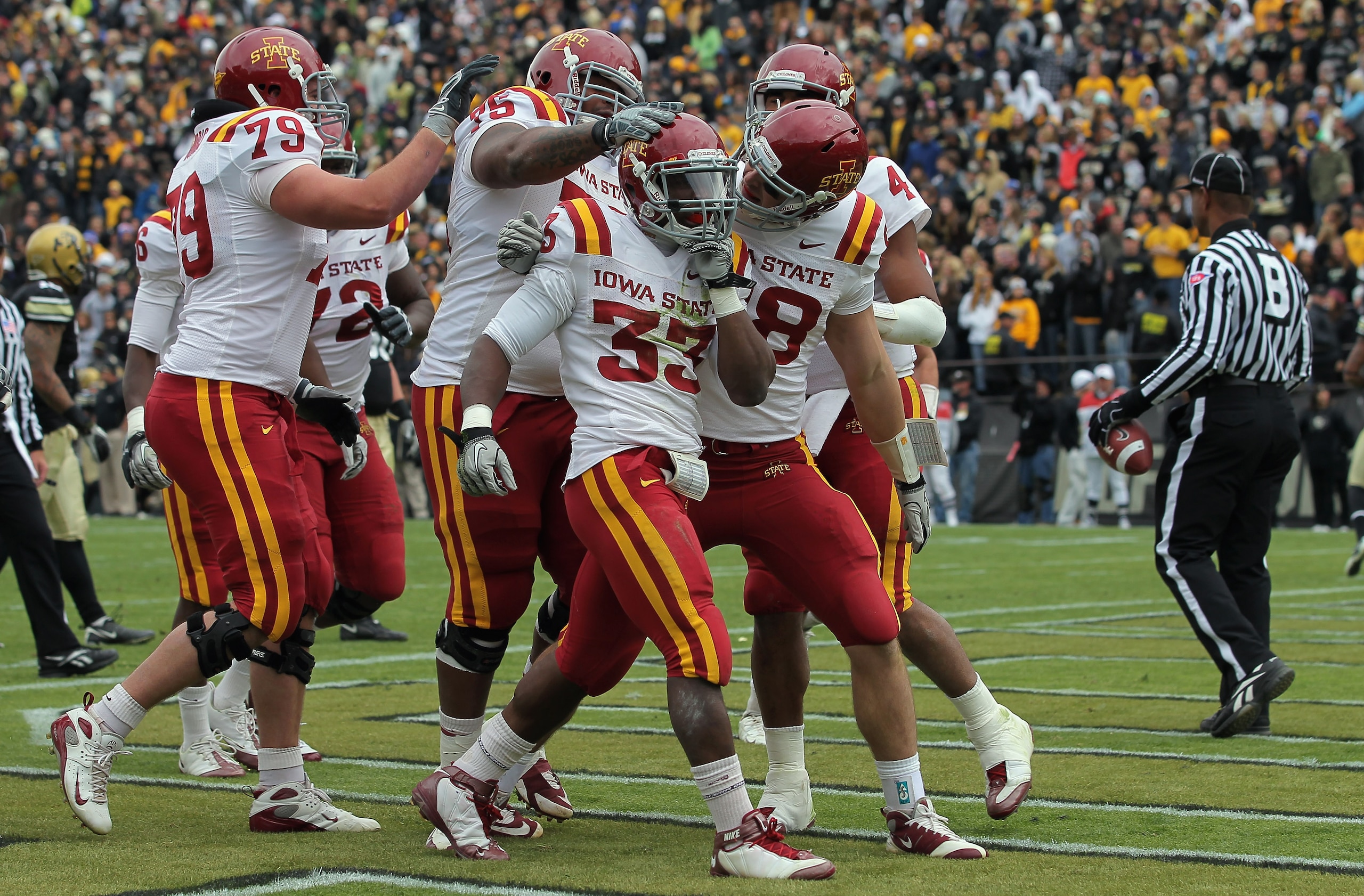 BOULDER, CO - NOVEMBER 13:  Alexander Robinson #33 of the Iowa State Cyclones celebrates his eight yard touchdown run in the second quarter with his teammates against the Colorado Buffaloes at Folsom Field on November 13, 2010 in Boulder, Colorado. Colora