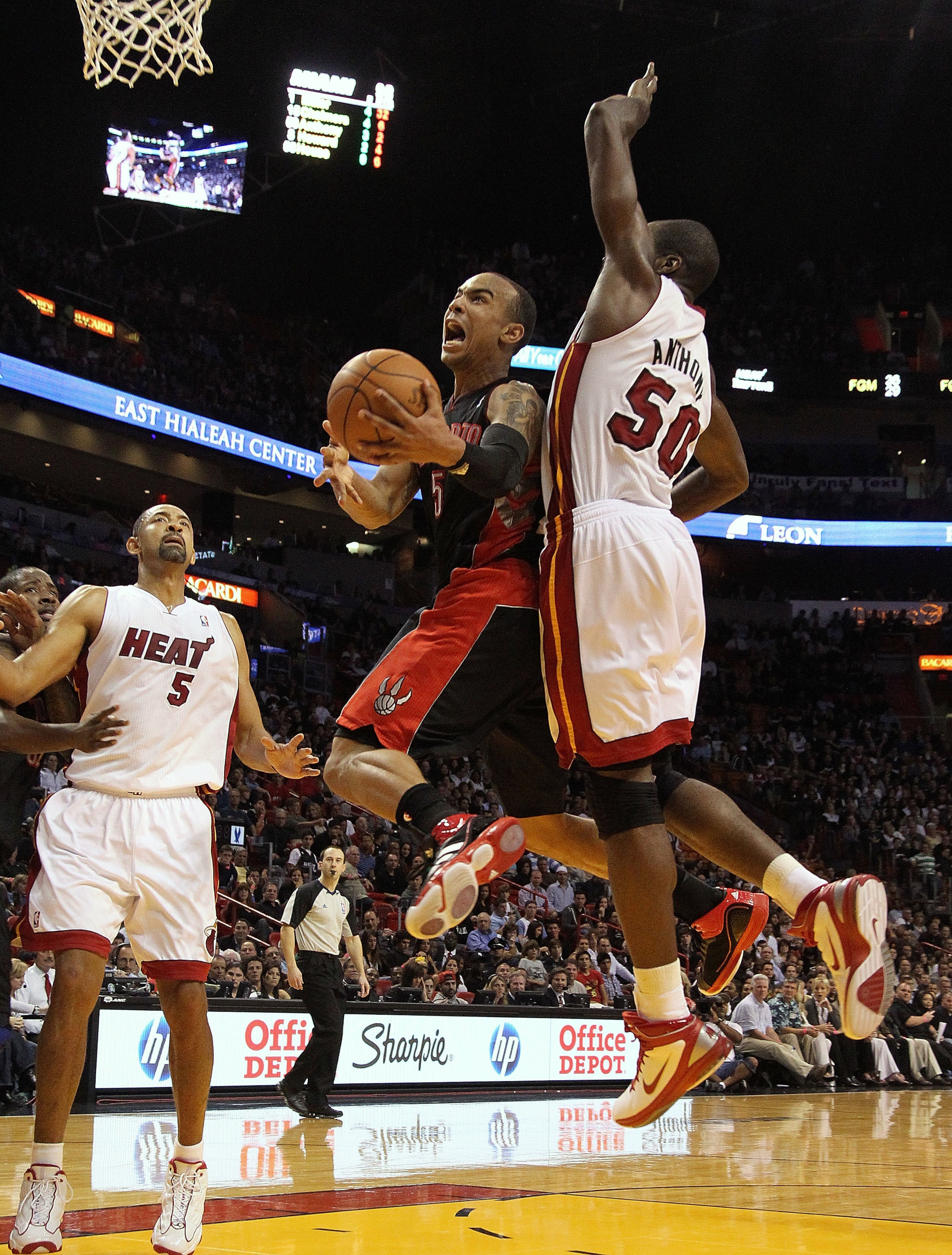MIAMI, FL - JANUARY 22:  Jerryd Bayless #5 of the Toronto Raptors goes up for a shot against Joel Anthony #50 of the Miami Heat during a game at American Airlines Arena on January 22, 2011 in Miami, Florida. NOTE TO USER: User expressly acknowledges and a