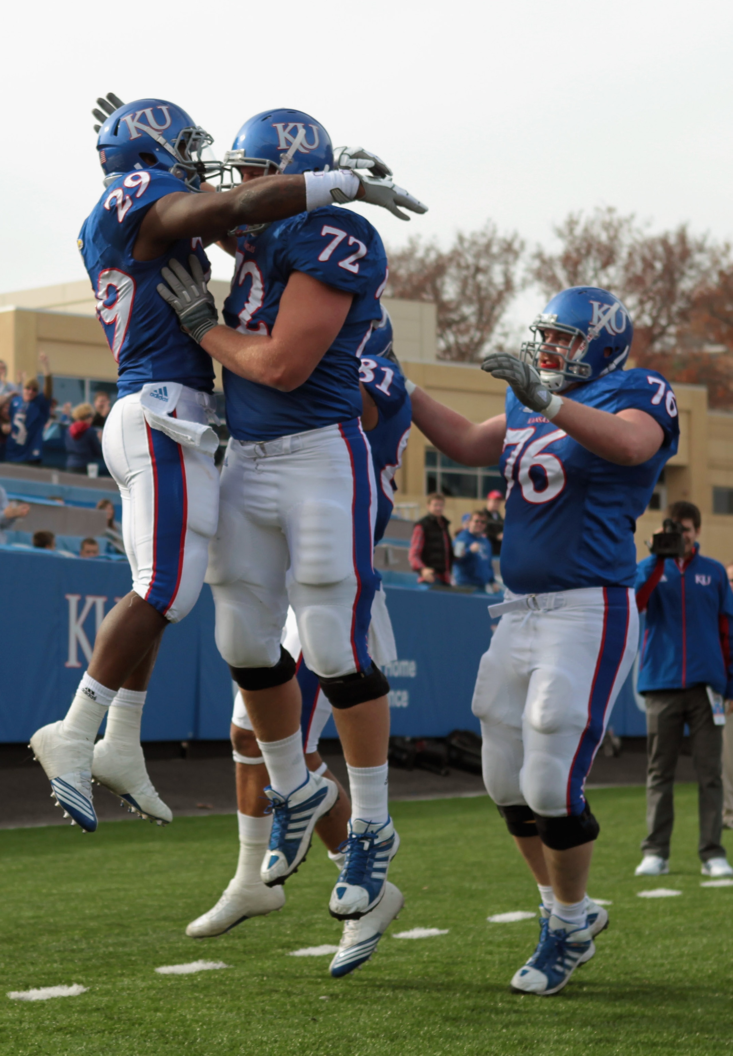 LAWRENCE, KS - NOVEMBER 20:  Running back James Sims #29 of the Kansas Jayhawks is congratulated by teammates after scoring a touchdown during the game against the Oklahoma State Cowboys on November 20, 2010 at Memorial Stadium in Lawrence, Kansas.  (Phot