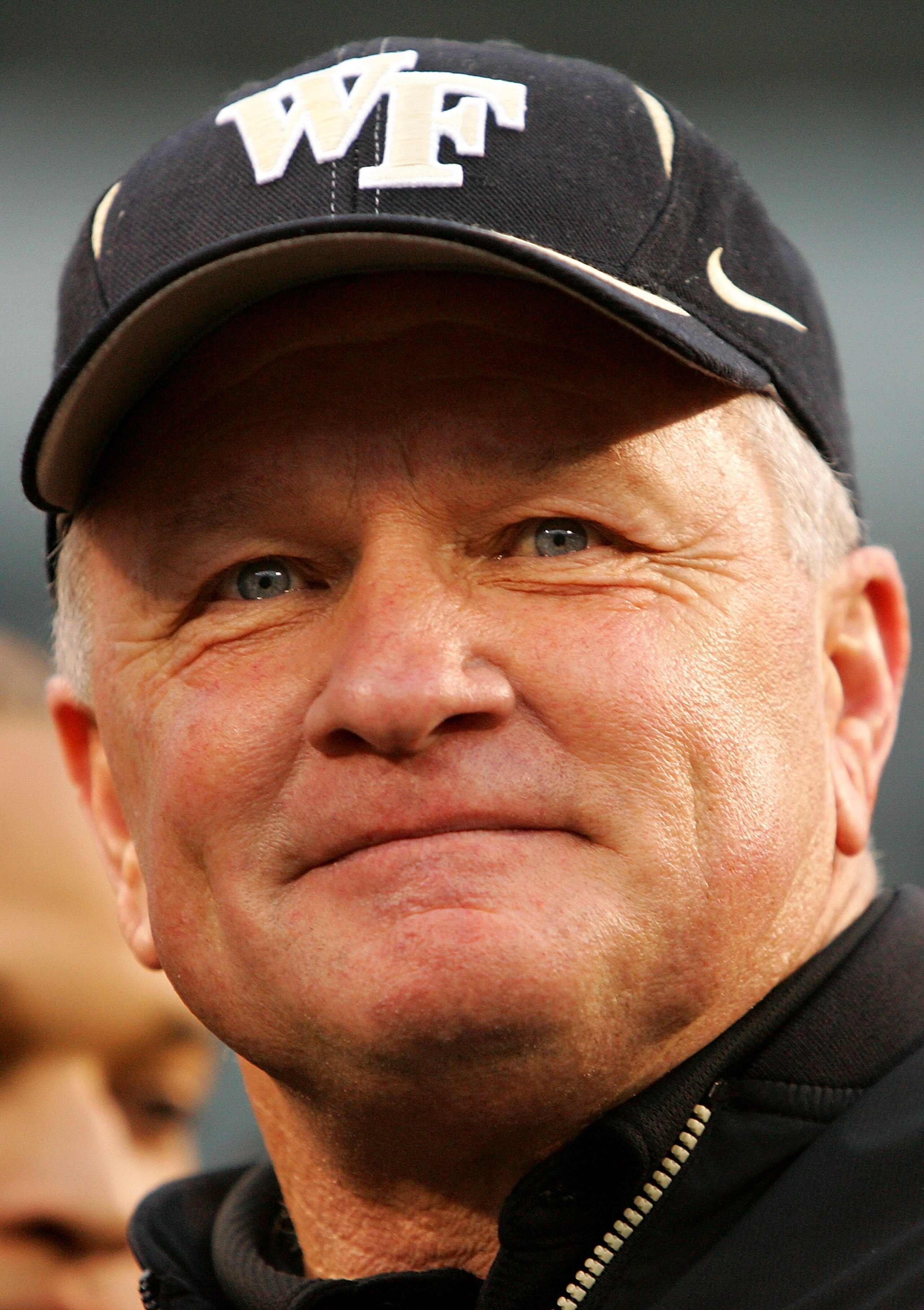 CHARLOTTE, NC - DECEMBER 29:  Head coach Jim Grobe of the Wake Forest Demon Deacons stands with his team to accept the winner's trophy after defeating the Connecticut Huskies 24-10 at Bank of America Stadium on December 29, 2007 in Charlotte, North Caroli