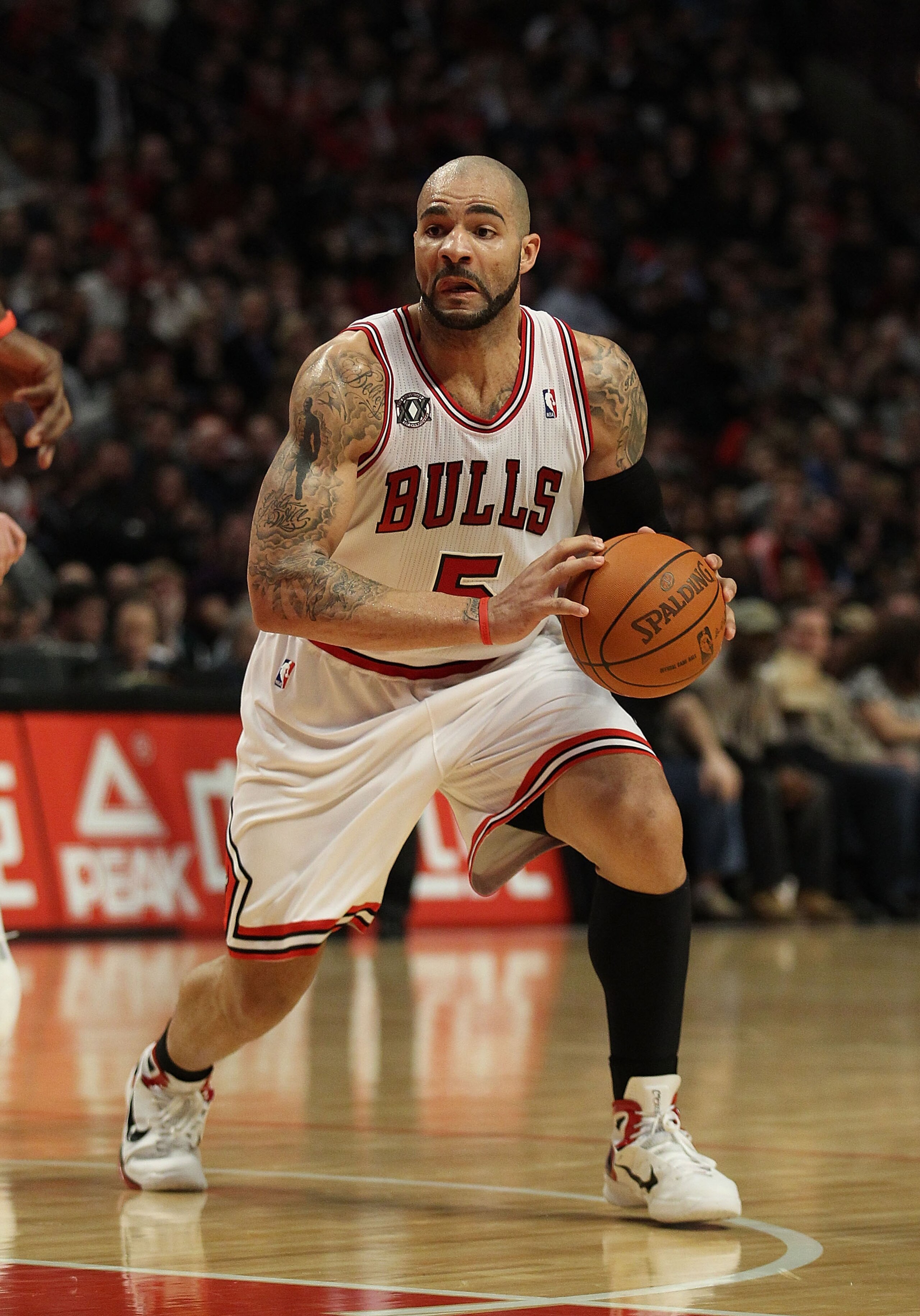 CHICAGO, IL - JANUARY 28: Carlos Boozer #5 of the Chicago Bulls looks to pass against the Orlando Magic at the United Center on January 28, 2011 in Chicago, Illinois. The Bulls defeated the Magic 99-90. NOTE TO USER: User expressly acknowledges and agrees