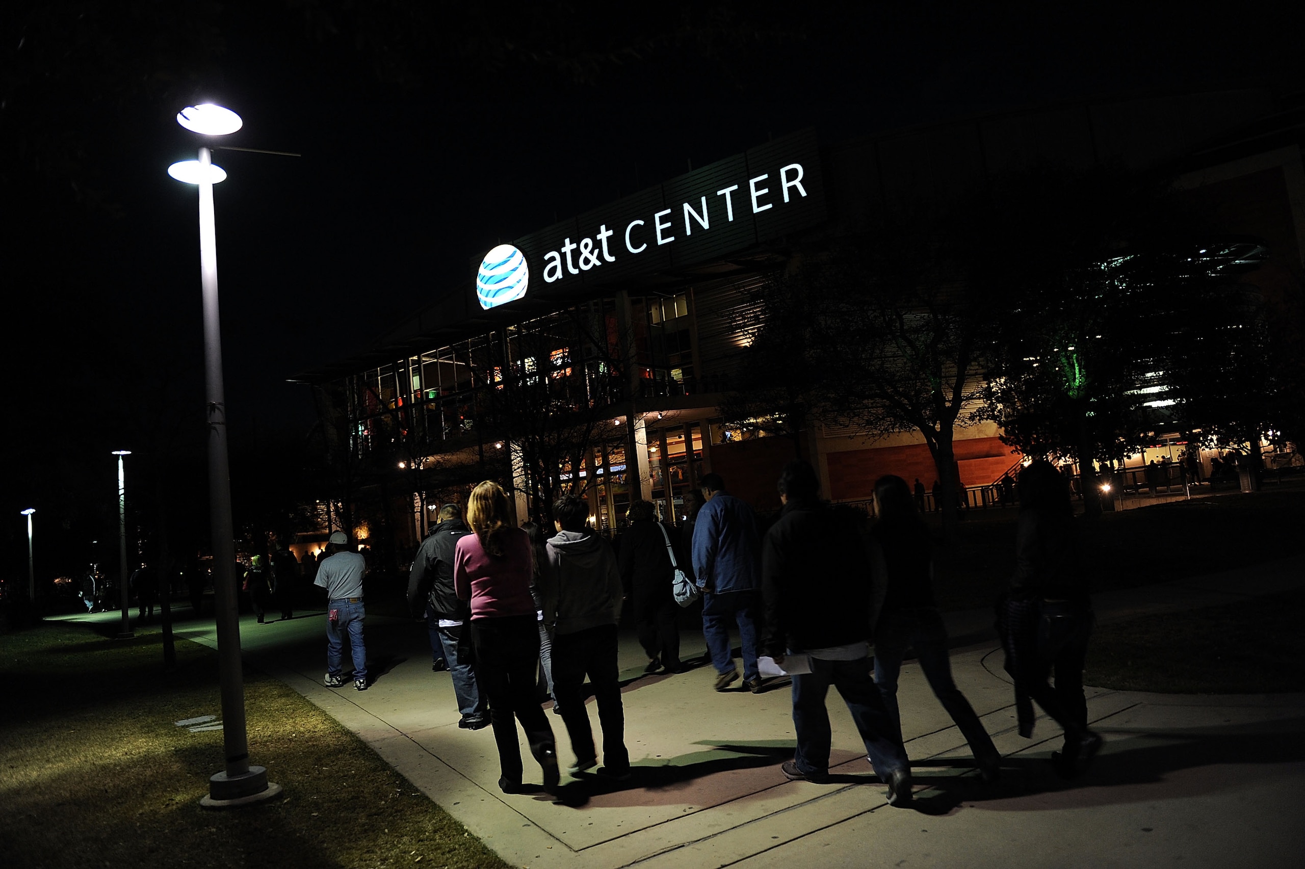 SAN ANTONIO - JANUARY 31:  NBA fans walk to the AT&T Center before a game between the New Orleans Hornets and the San Antonio Spurs on January 31, 2009 at AT&T Center in San Antonio, Texas.  NOTE TO USER: User expressly acknowledges and agrees that, by do