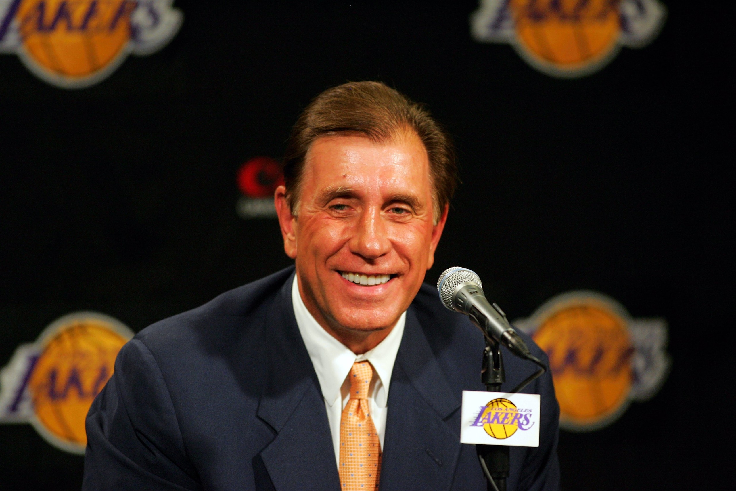 LOS ANGELES - JULY 10: Rudy Tomjanovich smiles during a press conference announcing him as the new head coach of the Los Angeles Lakers on July 10, 2004 at the Staples Center in Los Angeles, California.  (Photo by Ronald Martinez/Getty Images)