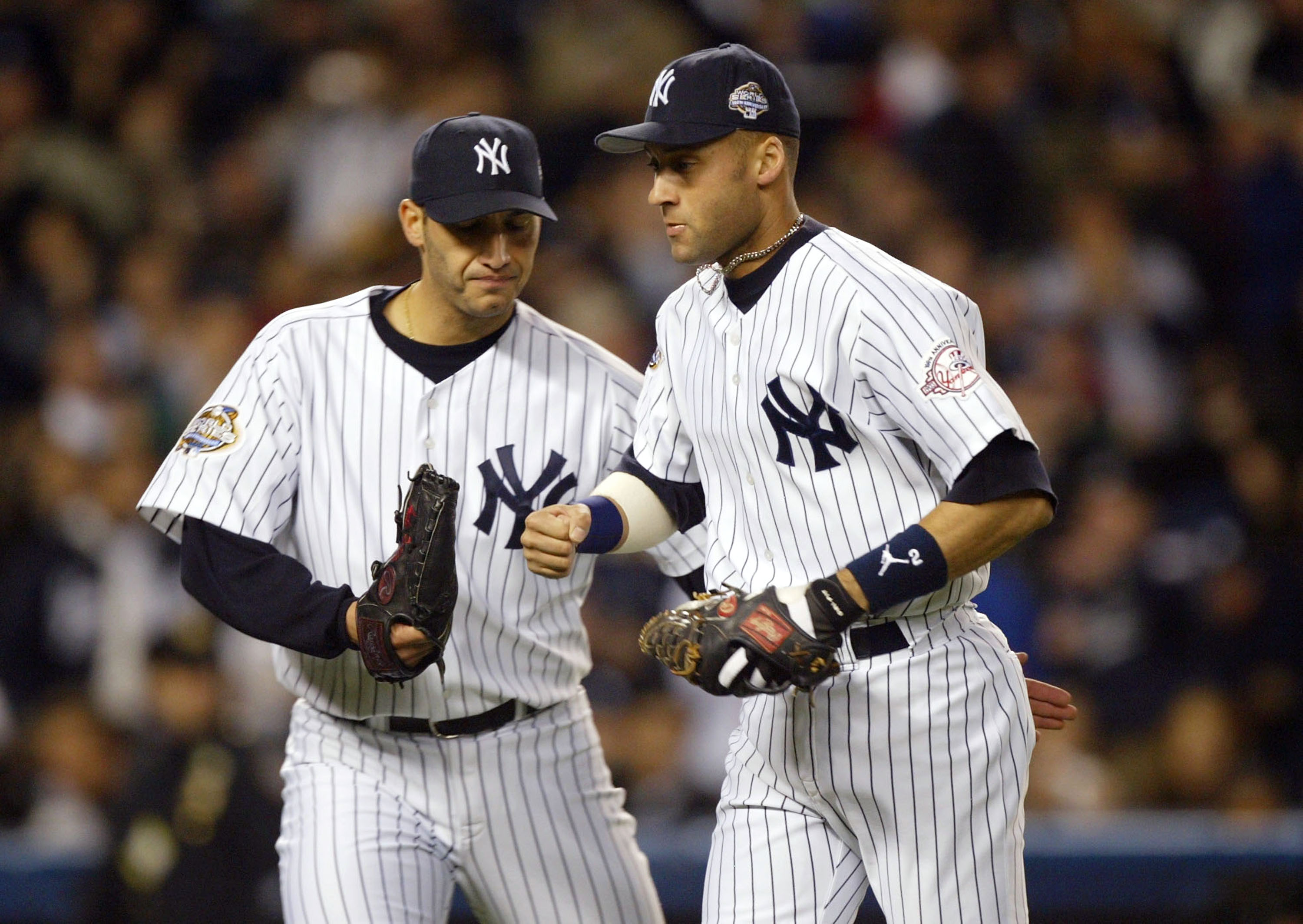 BRONX, NY - OCTOBER 25:  Starting pitcher Andy Pettitte #46 of the New York Yankees congratulates teammate Derek Jeter #2 after throwing out Mike Lowell #19 of the Florida Marlins in the forth inning during game six of the Major League Baseball World Seri