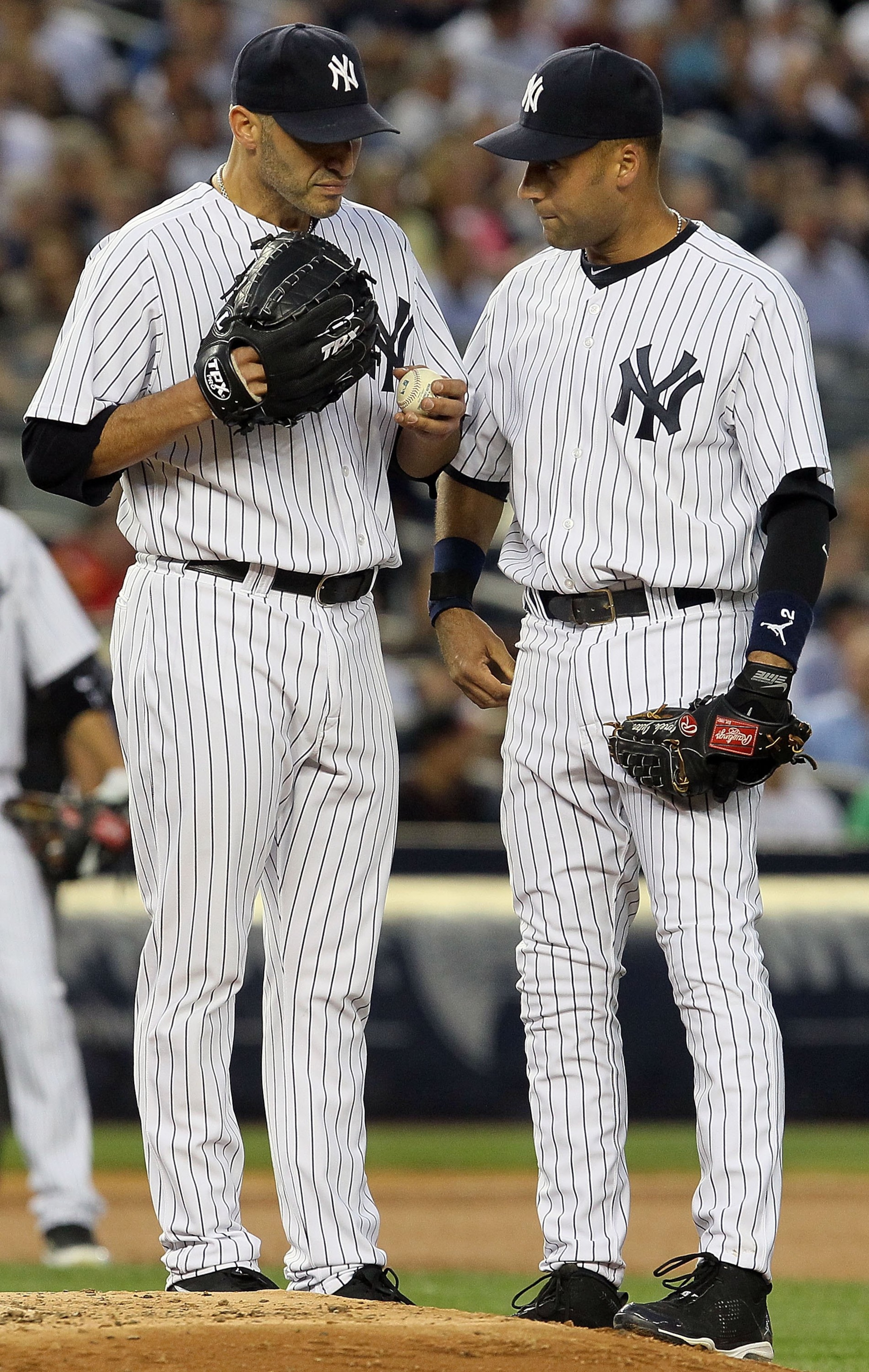 NEW YORK - JUNE 17:  Andy Pettitte #46 and Derek Jeter #2 of the New York Yankees talk against the Philadelphia Phillies on June 17, 2010 at Yankee Stadium in the Bronx borough of New York City.  (Photo by Jim McIsaac/Getty Images)