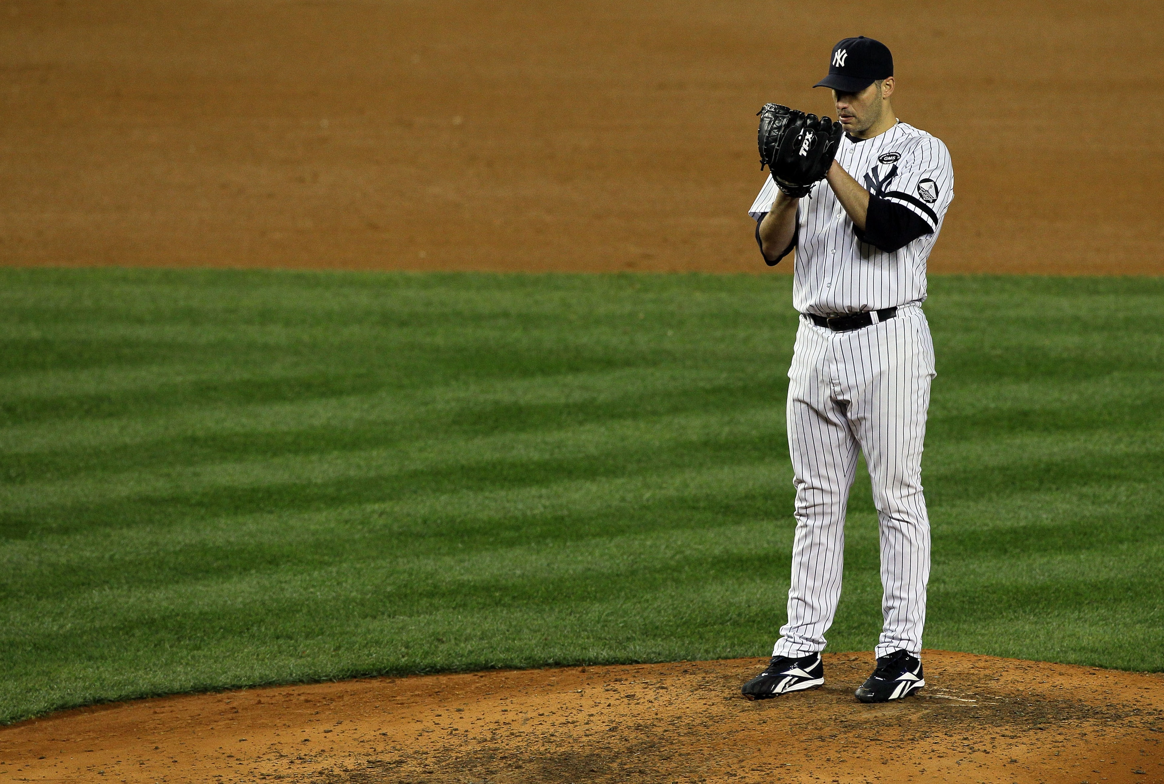 NEW YORK - OCTOBER 18: Starting pitcher Andy Pettitte #46 of the New York Yankees gets set to throw a pitch against the Texas Rangers in Game Three of the ALCS during the 2010 MLB Playoffs at Yankee Stadium on October 18, 2010 in New York, New York. (Ph NEW YORK - OCTOBER 18: Starting pitcher Andy Pettitte #46 of the New York Yankees gets set to throw a pitch against the Texas Rangers in Game Three of the ALCS during the 2010 MLB Playoffs at Yankee Stadium on October 18, 2010 in New York, New York. (Ph