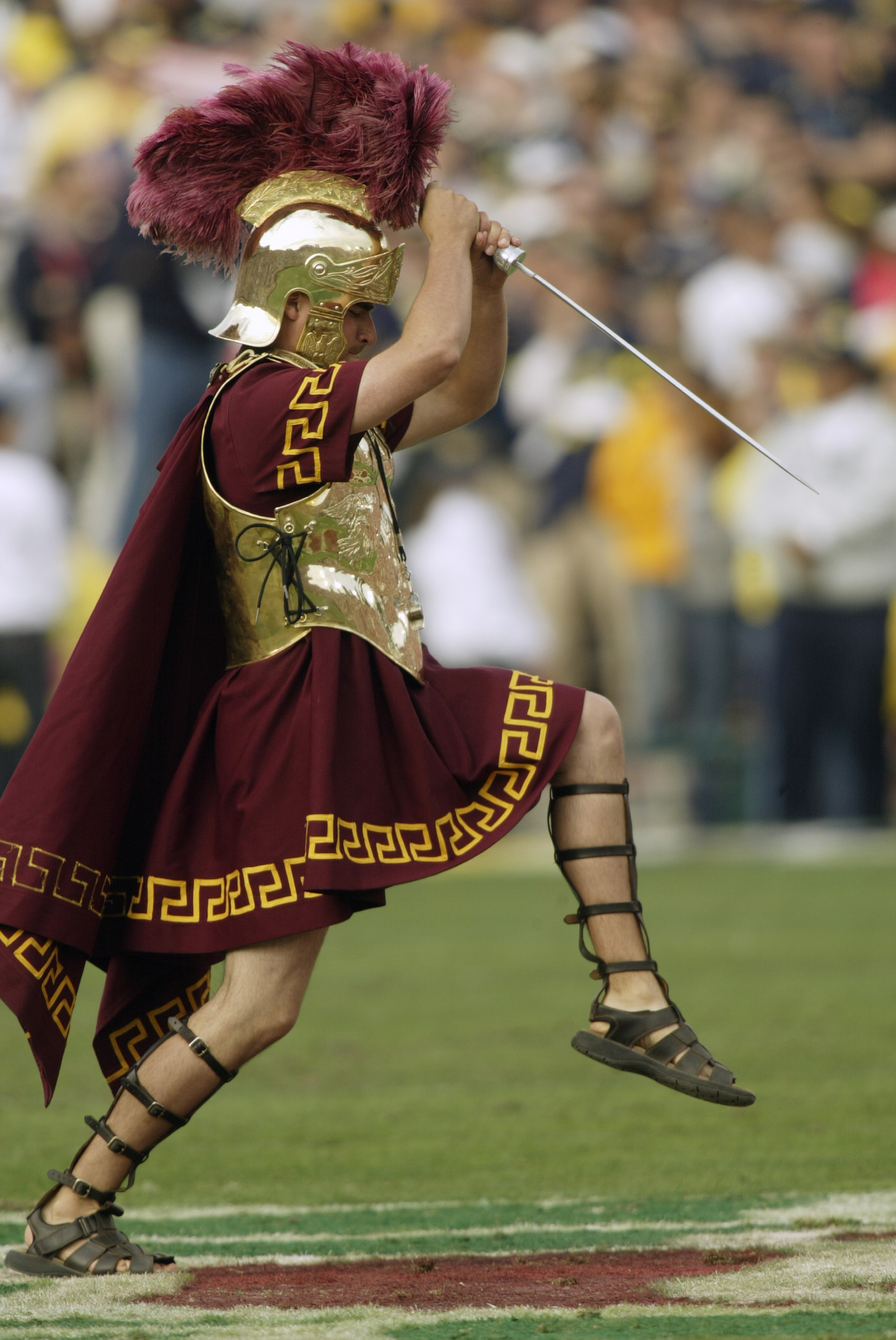 PASADENA, CA - JANUARY 1: Tommy Trojan, mascot of the USC Trojans entertains the crowd during an intermission in the 2004 Rose Bowl game against the Michigan Wolverines on January 1, 2004 at the Rose Bowl in Pasadena, California. USC defeated Michigan 28 PASADENA, CA - JANUARY 1: Tommy Trojan, mascot of the USC Trojans entertains the crowd during an intermission in the 2004 Rose Bowl game against the Michigan Wolverines on January 1, 2004 at the Rose Bowl in Pasadena, California. USC defeated Michigan 28