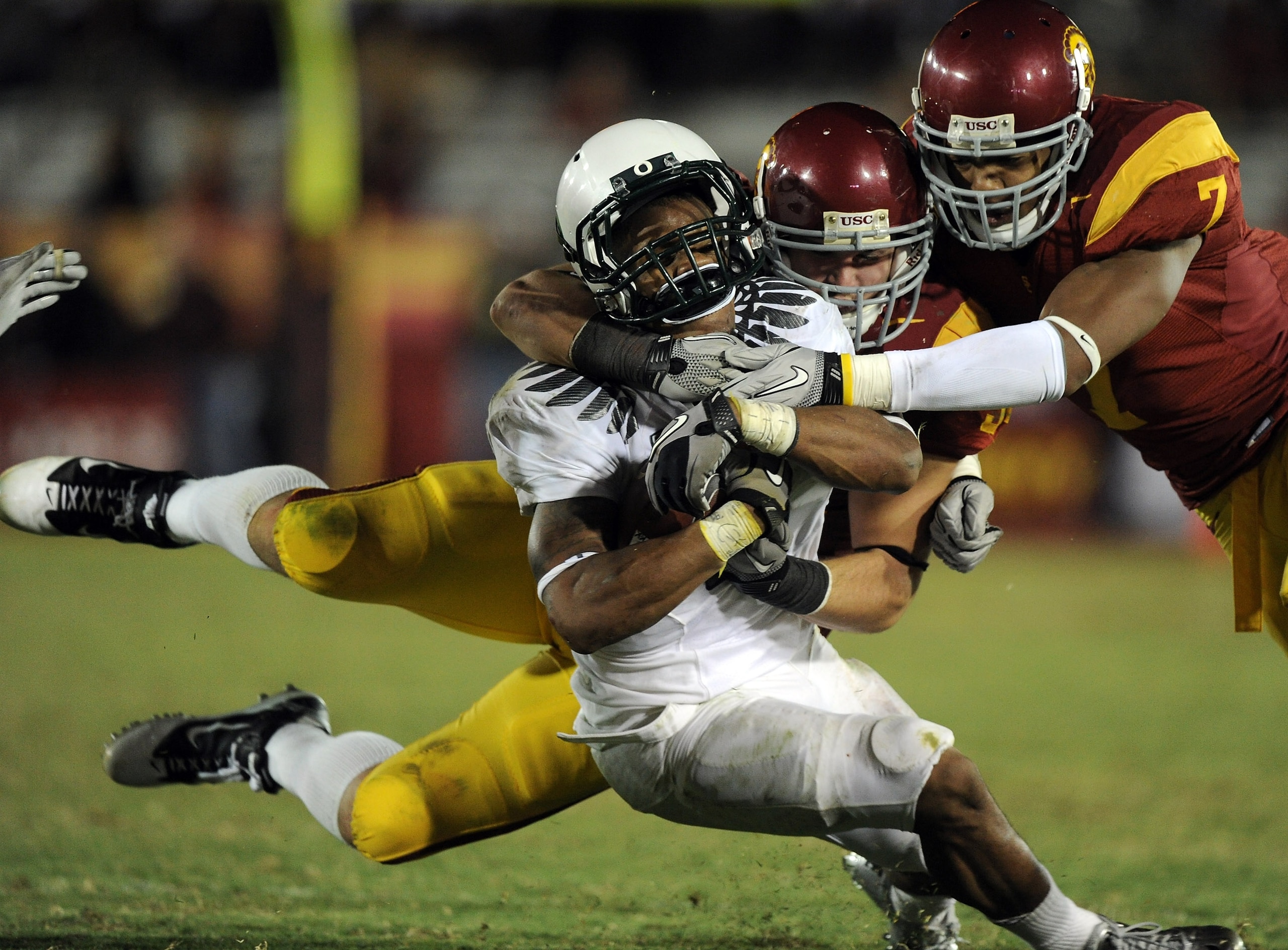 LOS ANGELES, CA - OCTOBER 30: LaMichael James #21 of the Oregon Ducks takes a hit from Chris Galippo and T.J. McDonald #7 of the USC Trojans during the fourth quarter at Los Angeles Memorial Coliseum on October 30, 2010 in Los Angeles, California. (Phot LOS ANGELES, CA - OCTOBER 30: LaMichael James #21 of the Oregon Ducks takes a hit from Chris Galippo and T.J. McDonald #7 of the USC Trojans during the fourth quarter at Los Angeles Memorial Coliseum on October 30, 2010 in Los Angeles, California. (Phot