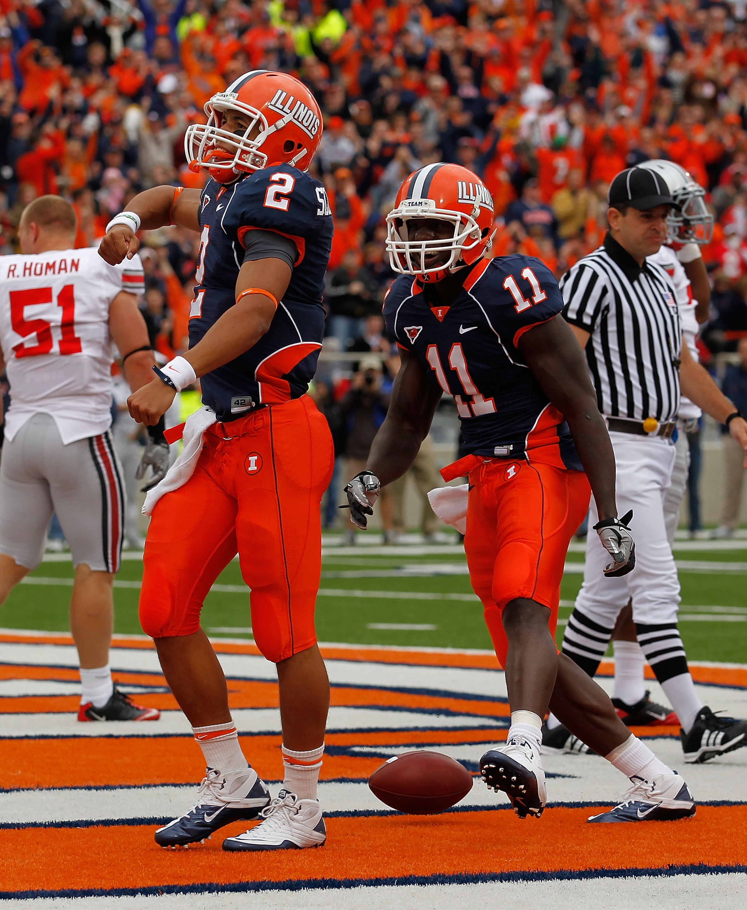 CHAMPAIGN, IL - OCTOBER 02: Nathan Scheelhaase #2 and Jarred Fayson #11 of the Illinois Fighting Illini celebrate Scheelhaases' touchdown against the Ohio State Buckeyes at Memorial Stadium on October 2, 2010 in Champaign, Illinois. Ohio State defeated Il