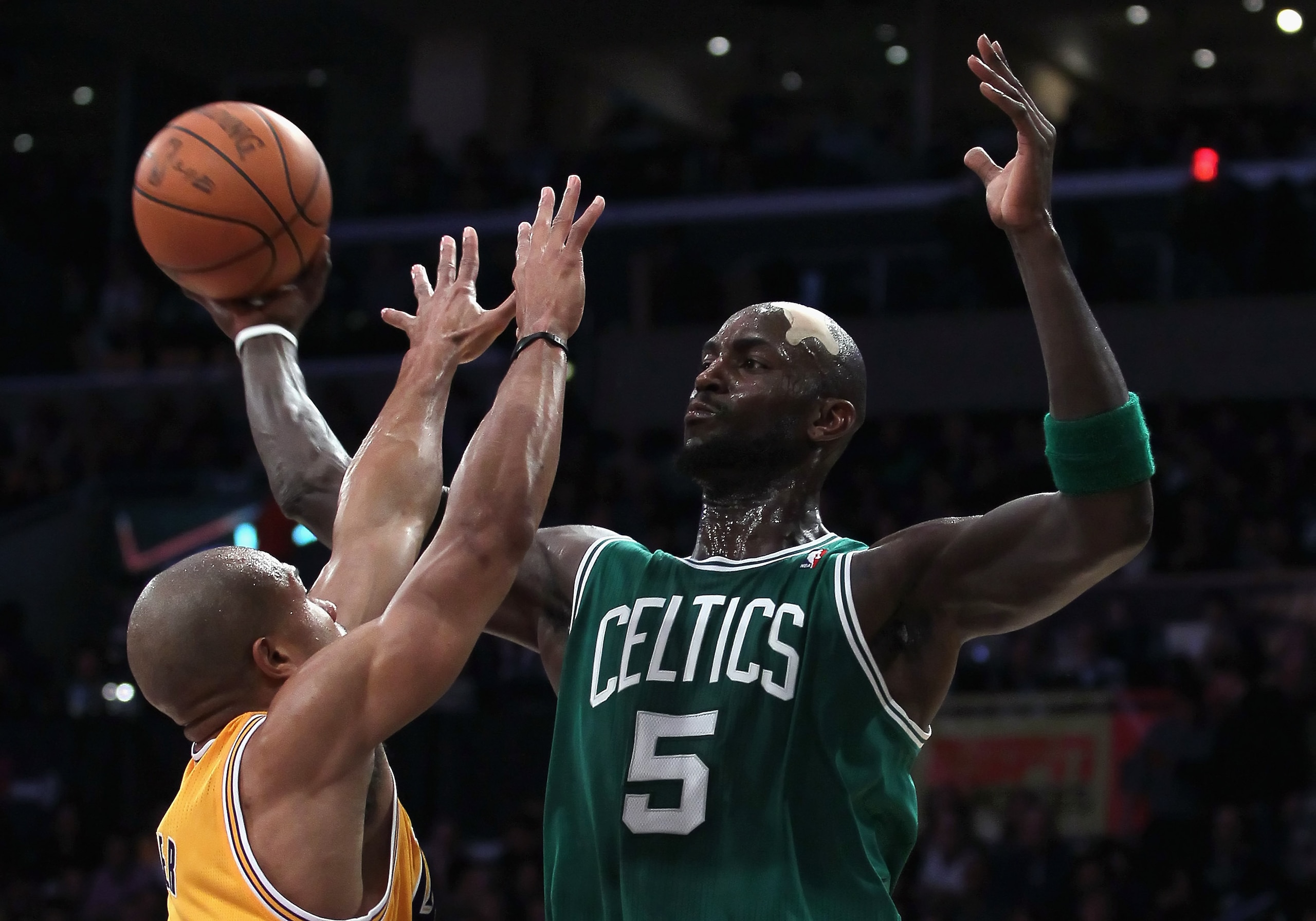 LOS ANGELES, CA - JANUARY 30:  Kevin Garnett #5 of the Boston Celtics is defended by Derek Fisher #2 of the Los Angeles Lakers in the second half at Staples Center on January 30, 2011 in Los Angeles, California. The Celtics defeated the Lakers 109-96.  (P