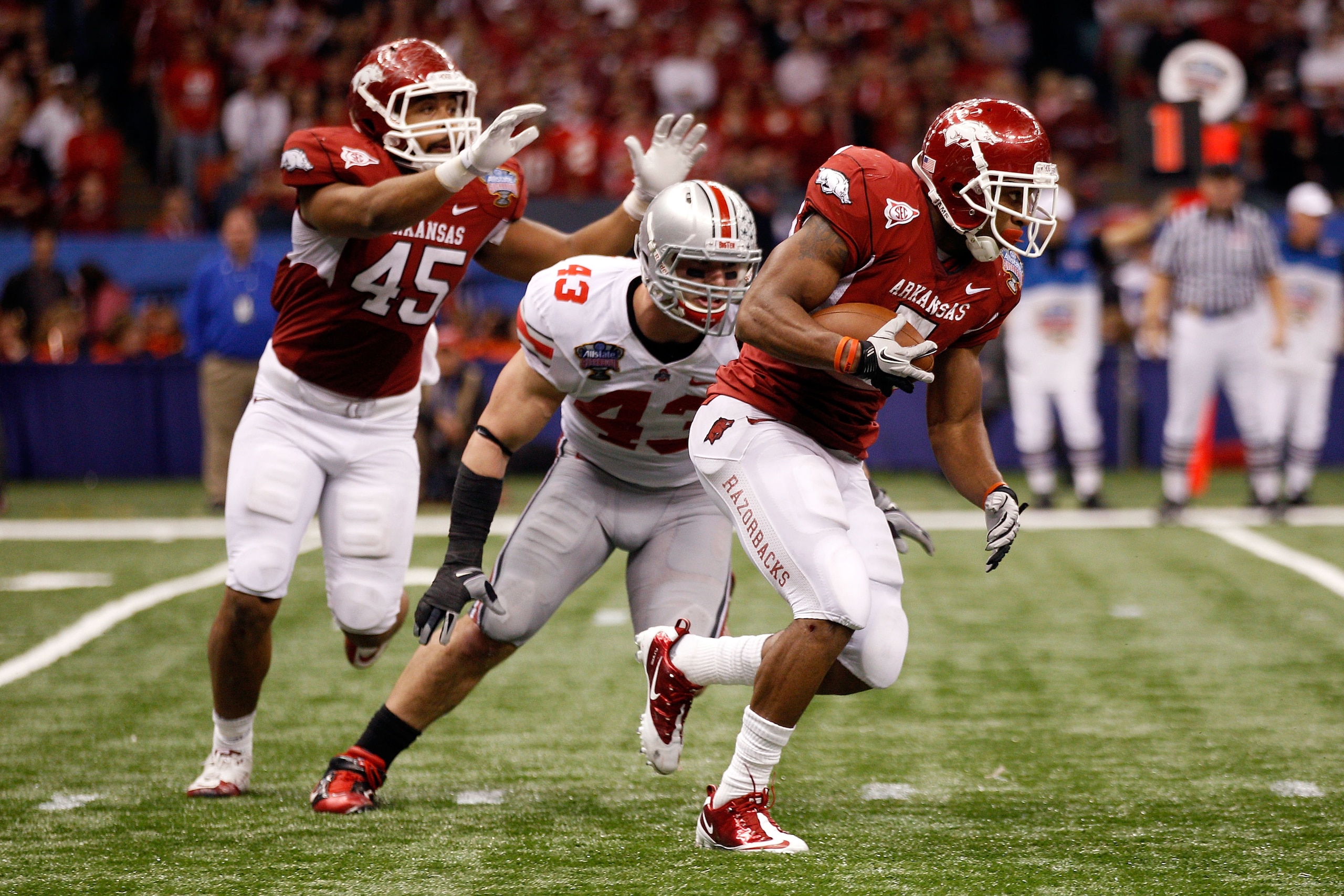 NEW ORLEANS, LA - JANUARY 04:  Knile Davis #7 of the Arkansas Razorbacks runs with the ball in front of Nathan Williams #43 of the Ohio State Buckeyes in the second half during the Allstate Sugar Bowl at the Louisiana Superdome on January 4, 2011 in New O