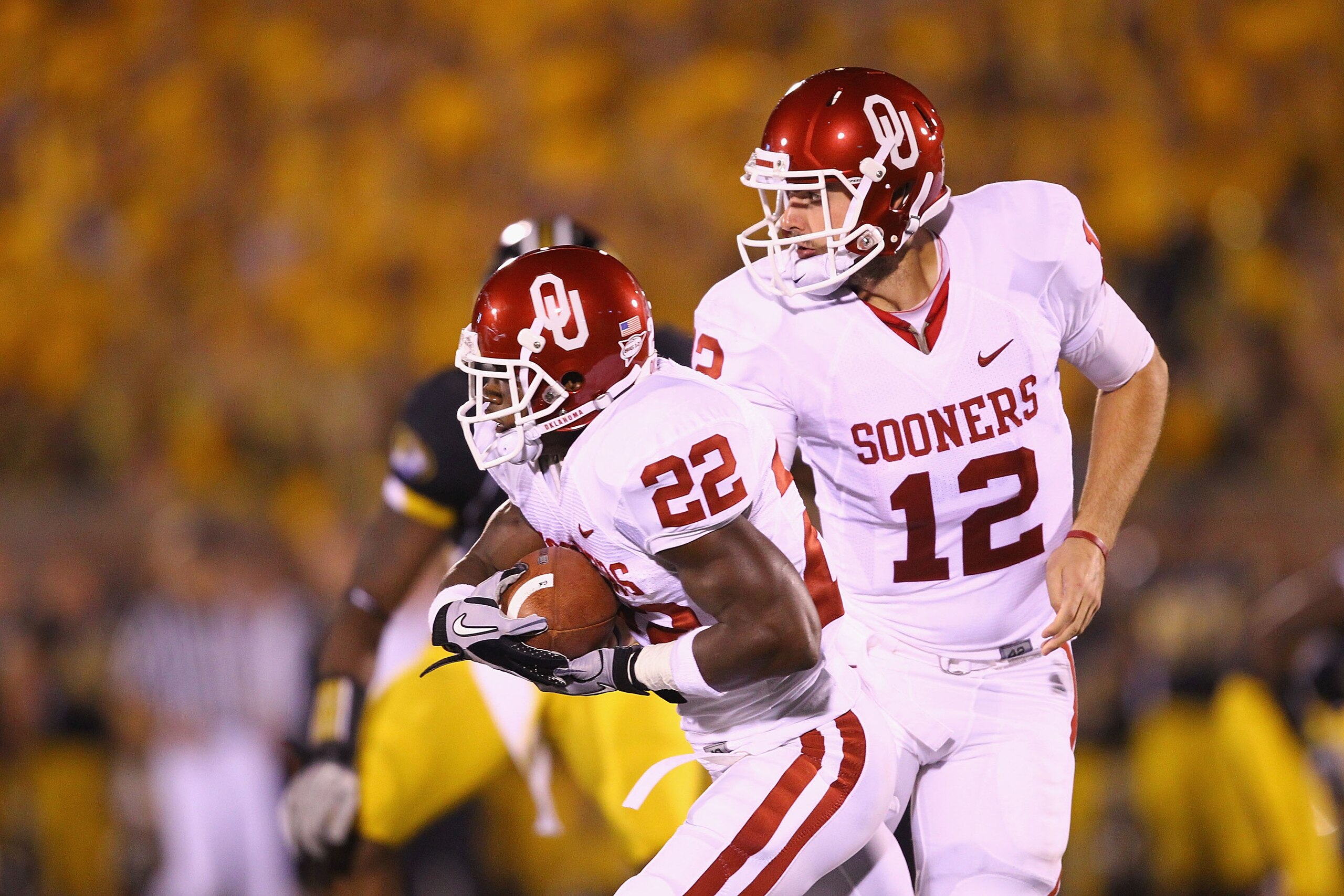 COLUMBIA, MO - OCTOBER 23: Landry Jones #12 of the Oklahoma Sooners hands the ball off to Roy Finch #22 also of the Oklahoma Sooners at Faurot Field/Memorial Stadium on October 23, 2010 in Columbia, Missouri.  The Tigers beat the Sooners 36-27.  (Photo by
