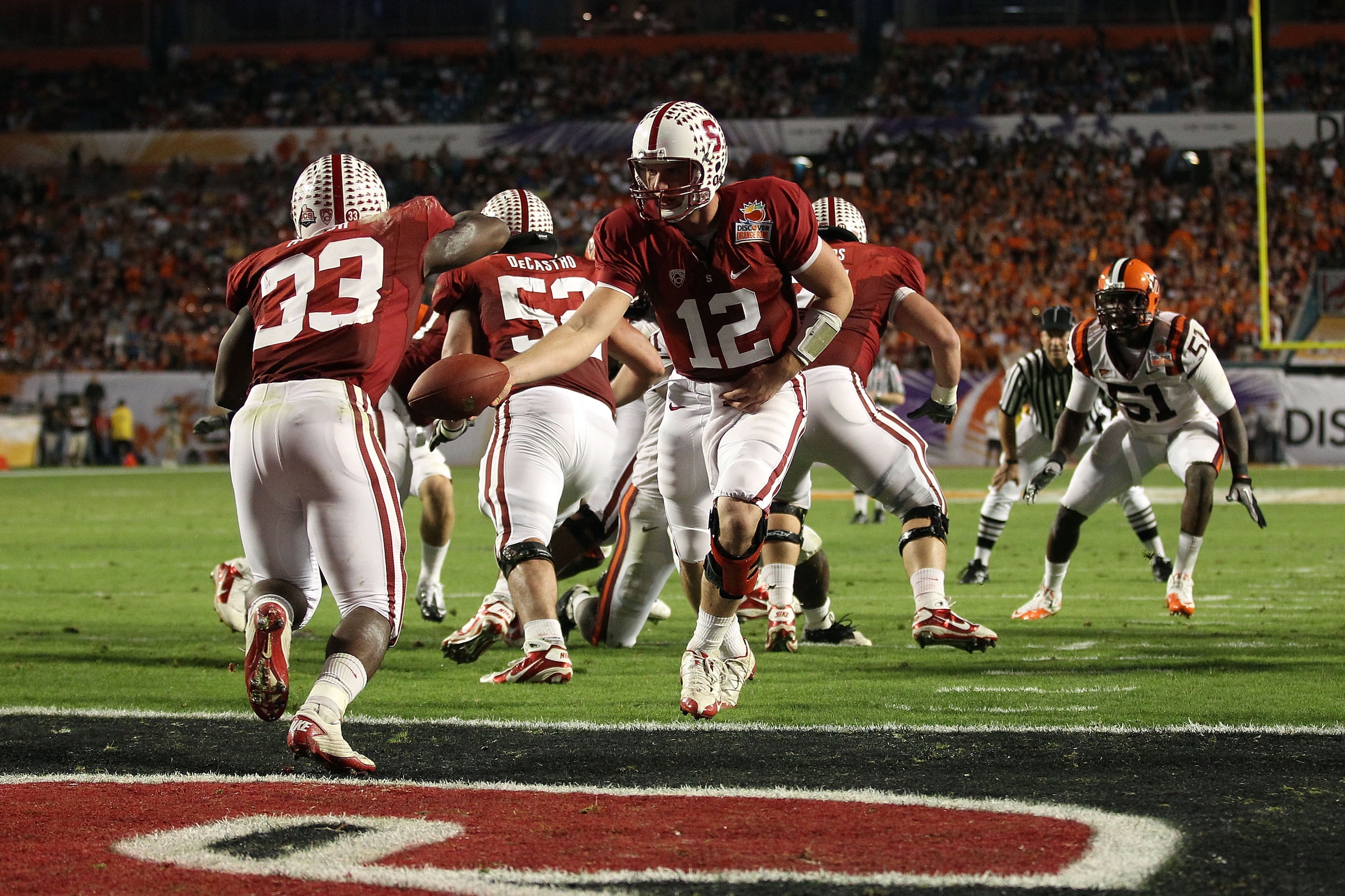 MIAMI, FL - JANUARY 03: Andrew Luck #12 of the Stanford Cardinal hands the ball off to Stepfan Taylor #33 against the Virginia Tech Hokies during the 2011 Discover Orange Bowl at Sun Life Stadium on January 3, 2011 in Miami, Florida. (Photo by Streeter Le