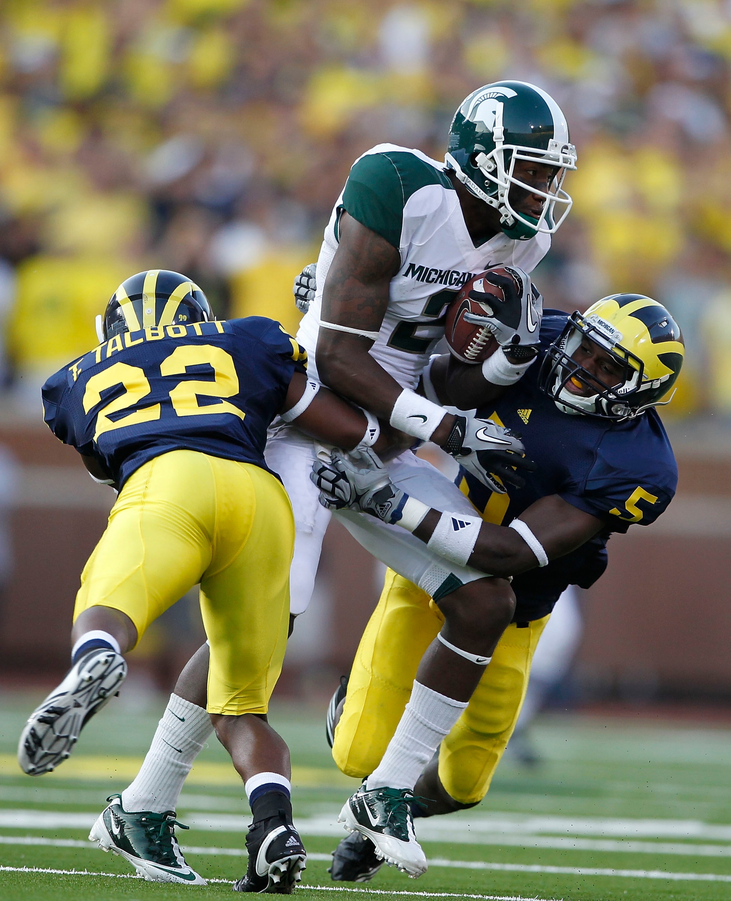ANN ARBOR, MI - OCTOBER 09: Mark Dell #2 of the Michigan State Spartans catches a 41 yard pass during the second quarter as Terrence Talbott #22 and Courtney Avery #5 of the Michigan Wolverines make the stop during the game on October 9, 2010 at Michigan