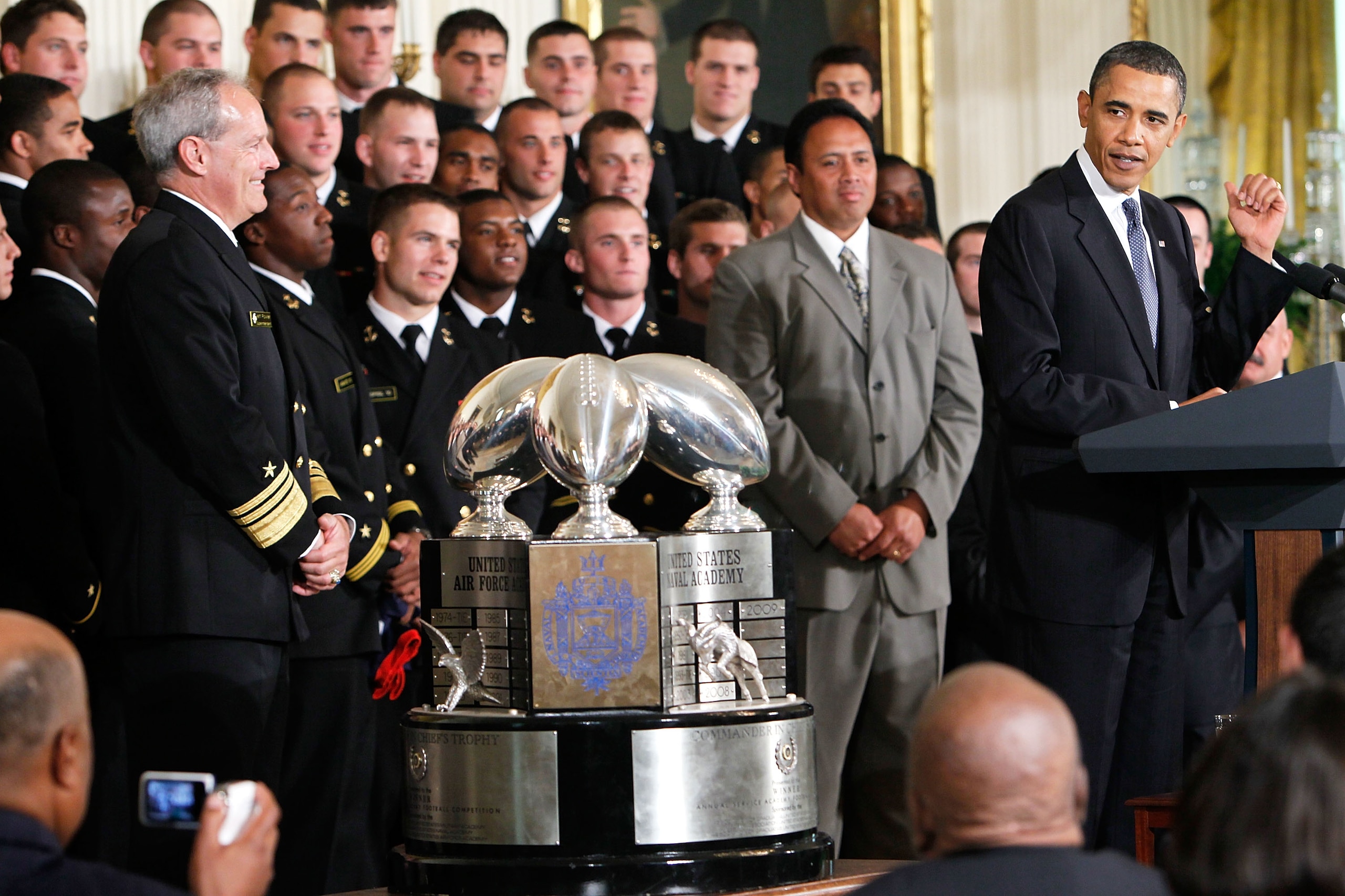 WASHINGTON - MAY 03:  U.S. President Barack Obama (R) speaks as he hosts members of the Navy football team Midshipmen during the presentation ceremony of the Commander-in-Chief's Trophy at the East Room of the White House May 3, 2010 in Washington, DC. Th