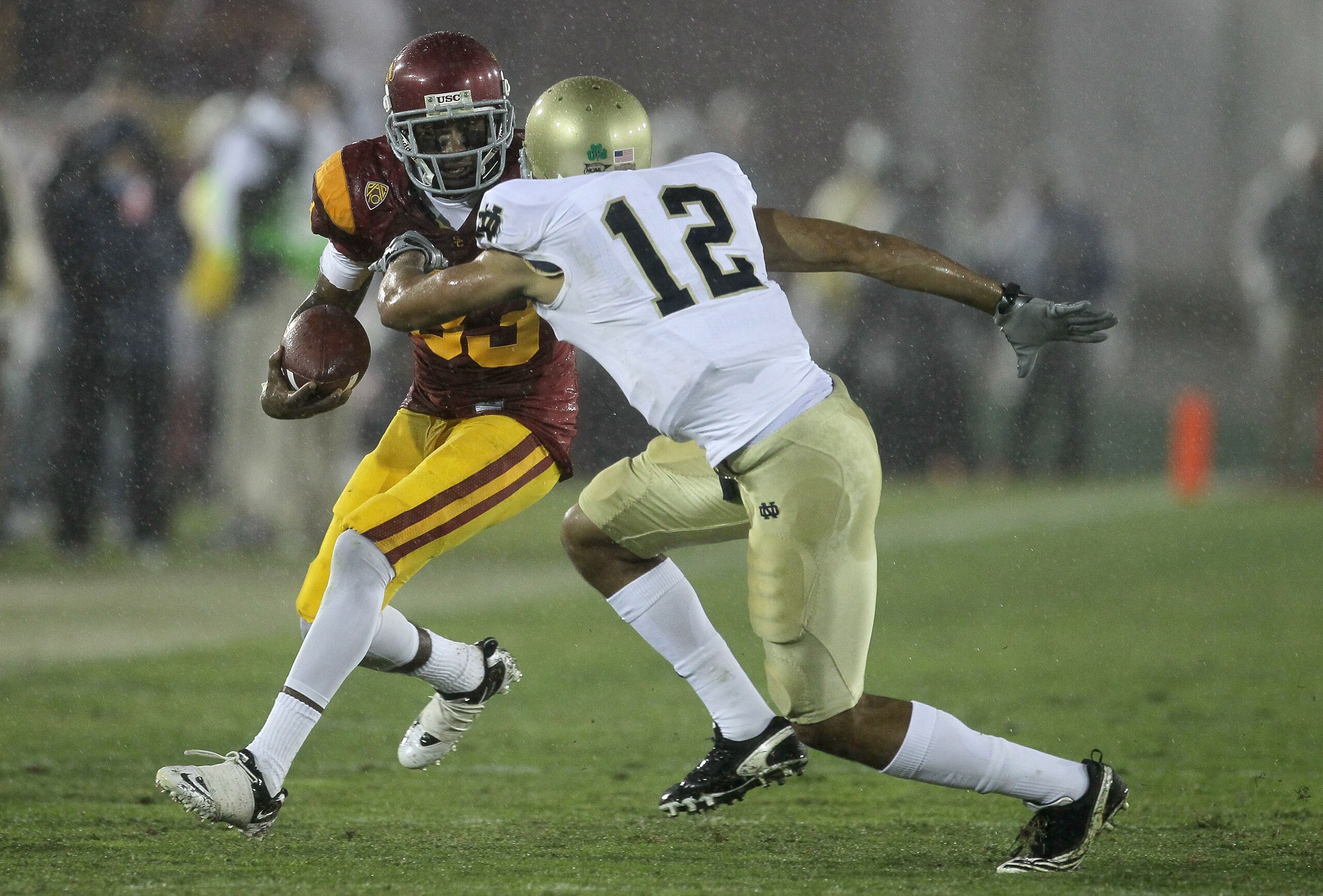 LOS ANGELES, CA - NOVEMBER 27:  Wide receiver Ronald Johsnon #83 of the USC Trojans carries the ball against cornerback Robert Blanton #12 of the Notre Dame Fighting Irish at the Los Angeles Memorial Coliseum on November 27, 2010 in Los Angeles, Californi