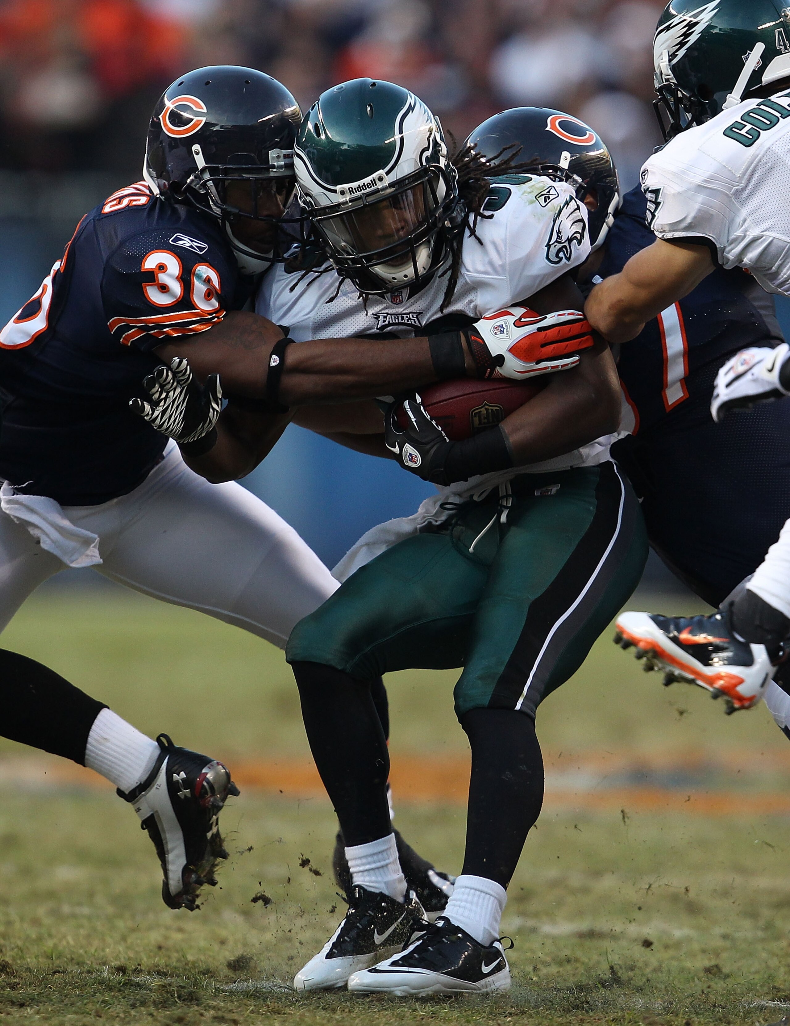 CHICAGO - NOVEMBER 28: Jorrick Calvin #38 of the Philadelphia Eagles is tackled by D.J. Moore #30 and Kellen Davis #87 of the Chicago Bears at Soldier Field on November 28, 2010 in Chicago, Illinois. The Bears defeated the Eagles 31-26. (Photo by Jonathan CHICAGO - NOVEMBER 28: Jorrick Calvin #38 of the Philadelphia Eagles is tackled by D.J. Moore #30 and Kellen Davis #87 of the Chicago Bears at Soldier Field on November 28, 2010 in Chicago, Illinois. The Bears defeated the Eagles 31-26. (Photo by Jonathan