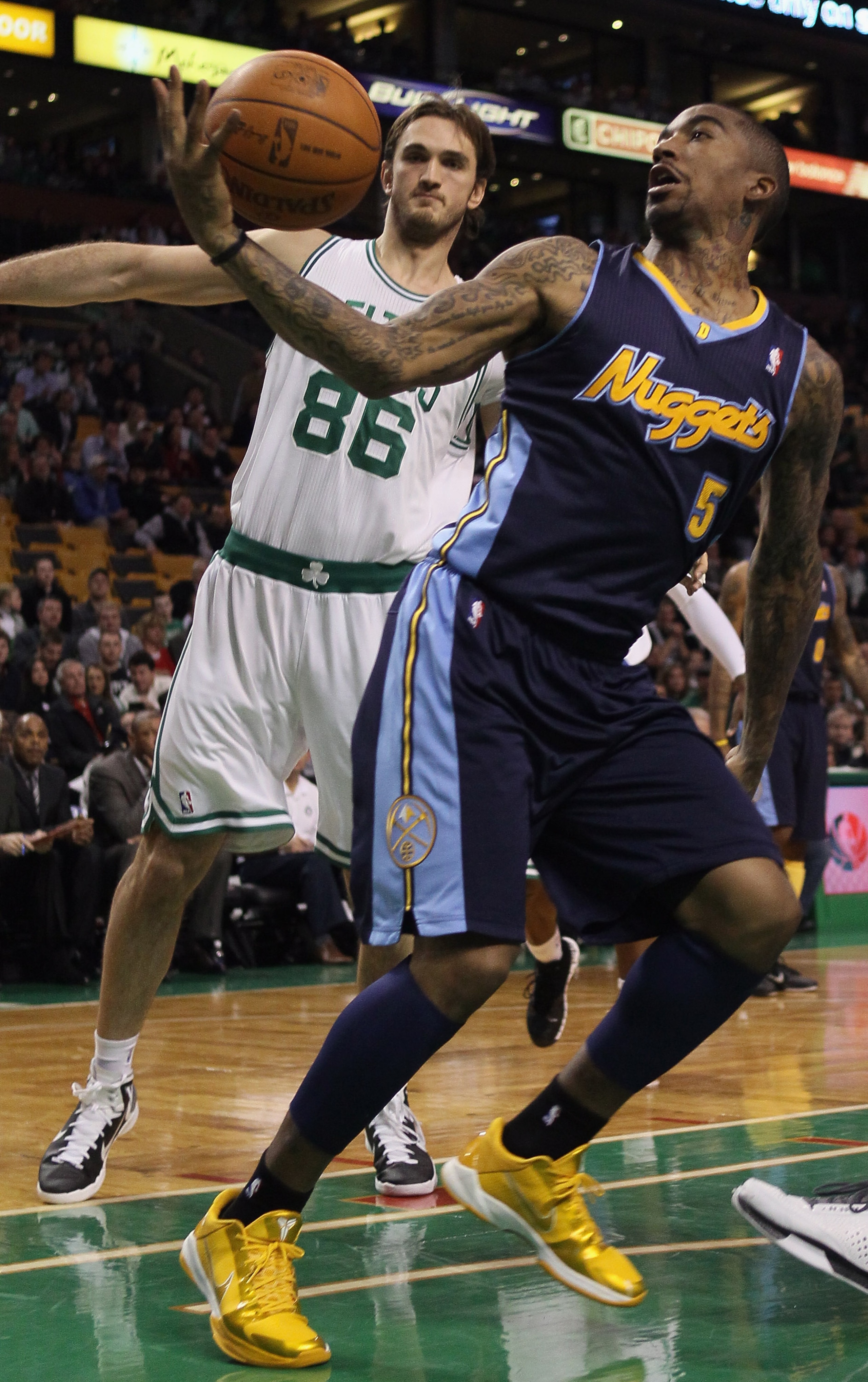BOSTON, MA - DECEMBER 08: J.R. Smith #5 of the Denver Nuggets tries to hang on to the ball as Semih Erden #86 of the Boston Celtics defends on December 8, 2010 at the TD Garden in Boston, Massachusetts. The Celtics defeated the Nuggets 105-89. NOTE TO US BOSTON, MA - DECEMBER 08: J.R. Smith #5 of the Denver Nuggets tries to hang on to the ball as Semih Erden #86 of the Boston Celtics defends on December 8, 2010 at the TD Garden in Boston, Massachusetts. The Celtics defeated the Nuggets 105-89. NOTE TO US
