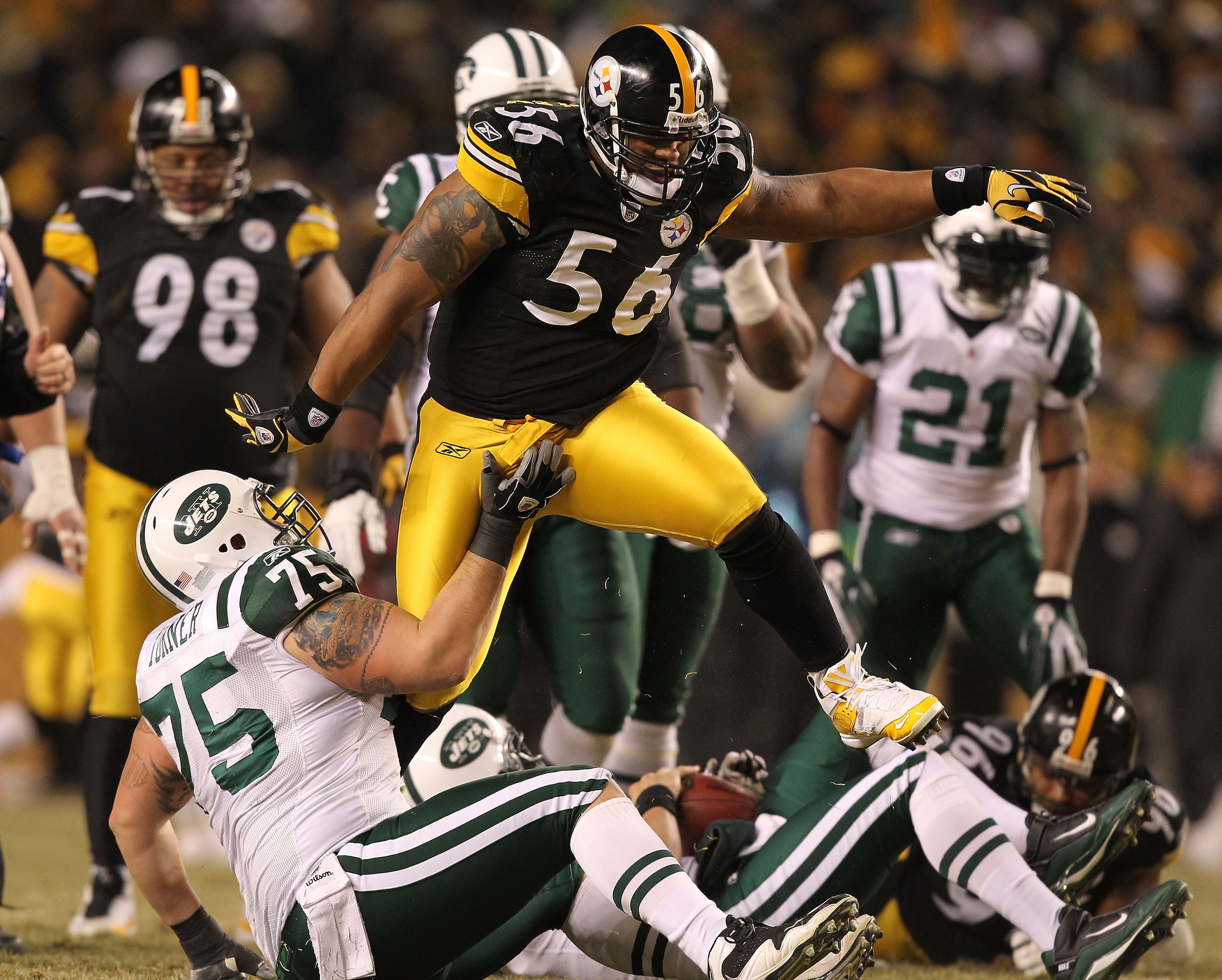 PITTSBURGH, PA - JANUARY 23: LaMarr Woodley #56 of the Pittsburgh Steelers jumps over Robert Turner #75 of the New York Jets after a sack during the 2011 AFC Championship game at Heinz Field on January 23, 2011 in Pittsburgh, Pennsylvania. (Photo by Al PITTSBURGH, PA - JANUARY 23: LaMarr Woodley #56 of the Pittsburgh Steelers jumps over Robert Turner #75 of the New York Jets after a sack during the 2011 AFC Championship game at Heinz Field on January 23, 2011 in Pittsburgh, Pennsylvania. (Photo by Al
