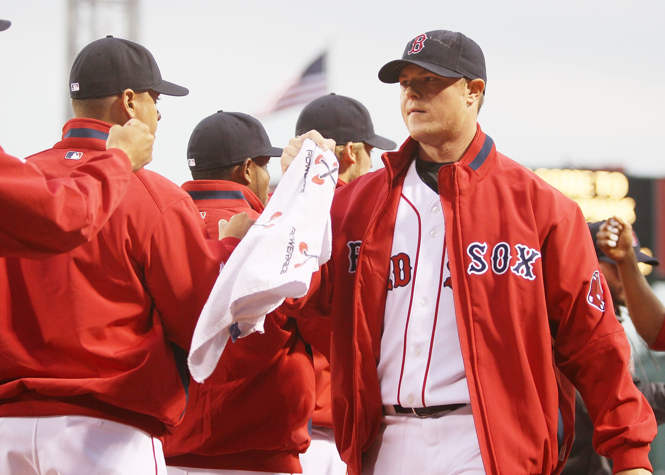 BOSTON - APRIL 06:  Jon Lester #31 of the Boston Red Sox is greeted by the bullpen as he come in after warming up before the game against the New York Yankees on April 6, 2010 at Fenway Park in Boston, Massachusetts.  (Photo by Elsa/Getty Images)