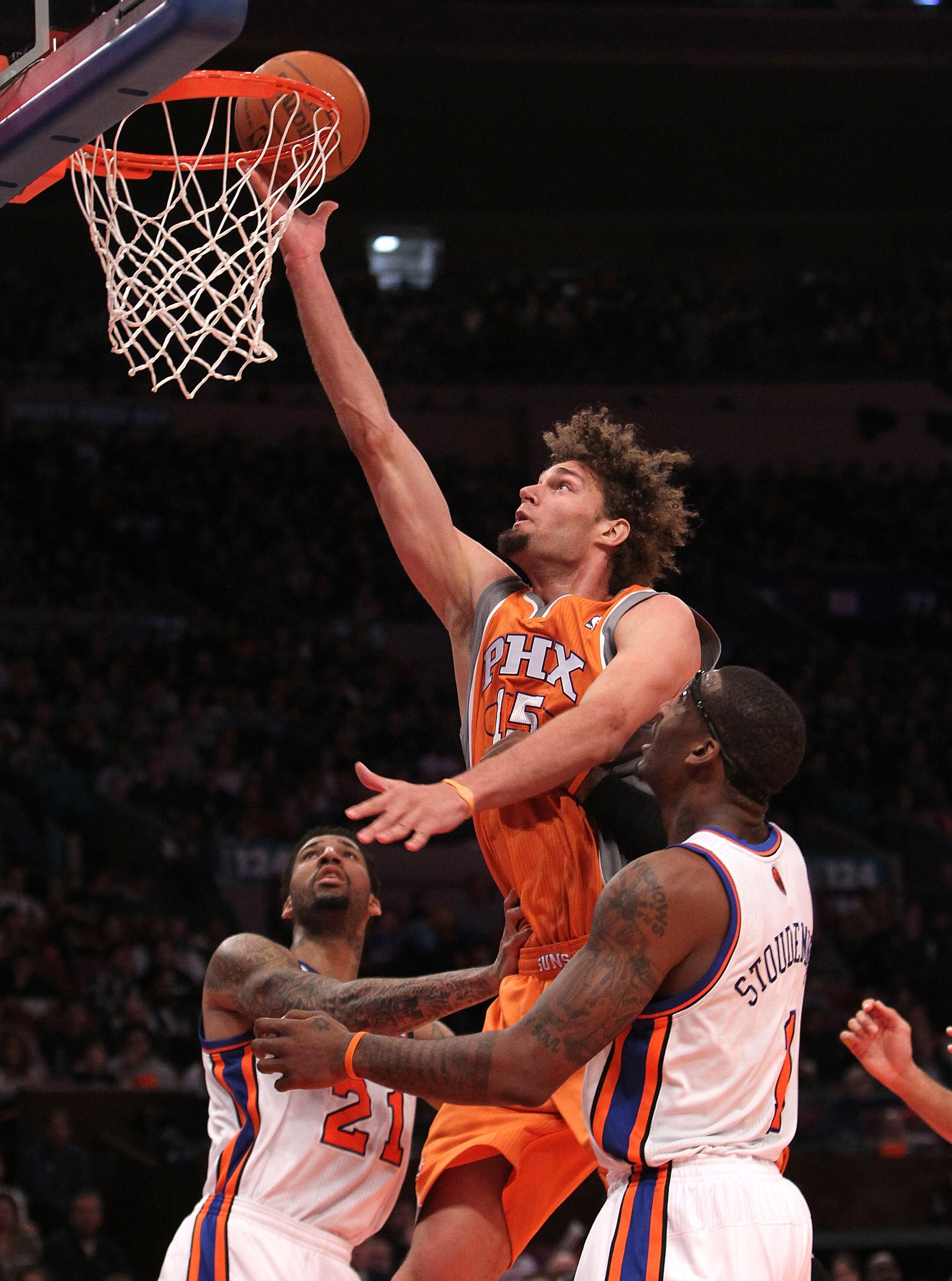 NEW YORK, NY - JANUARY 17: Robin Lopez #15 of the Phoenix Suns shoots the ball over Wilson Chandler #21 and Amar'e Stoudemire #1 of the New York Knicks at Madison Square Garden on January 17, 2011 in New York City. NOTE TO USER: User expressly acknowledge