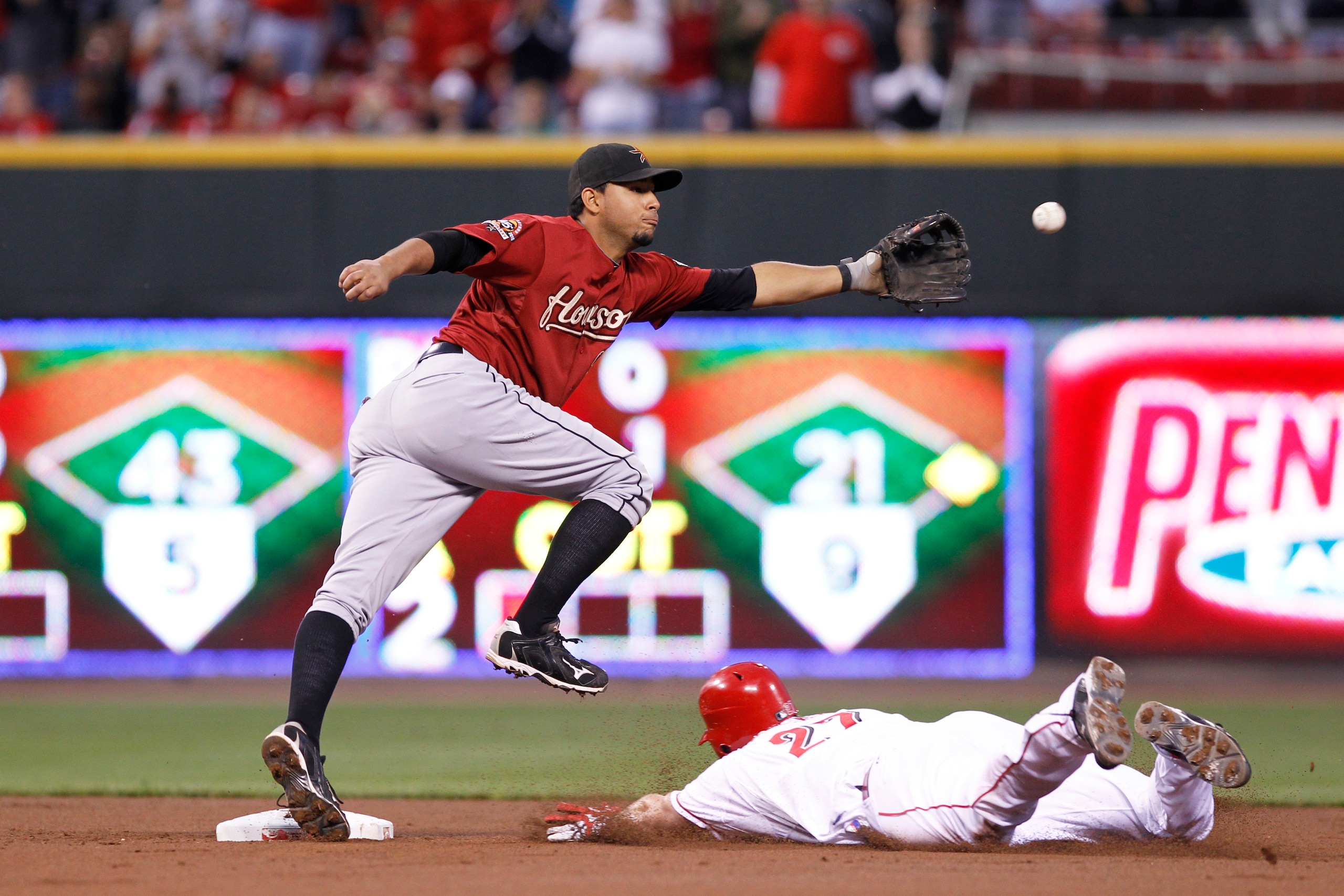 CINCINNATI, OH - SEPTEMBER 28: Scott Rolen #27 of the Cincinnati Reds reaches second base on an error ahead of Angel Sanchez #36 of the Houston Astros at Great American Ball Park on September 28, 2010 in Cincinnati, Ohio. The Reds won 3-2 to clinch the NL