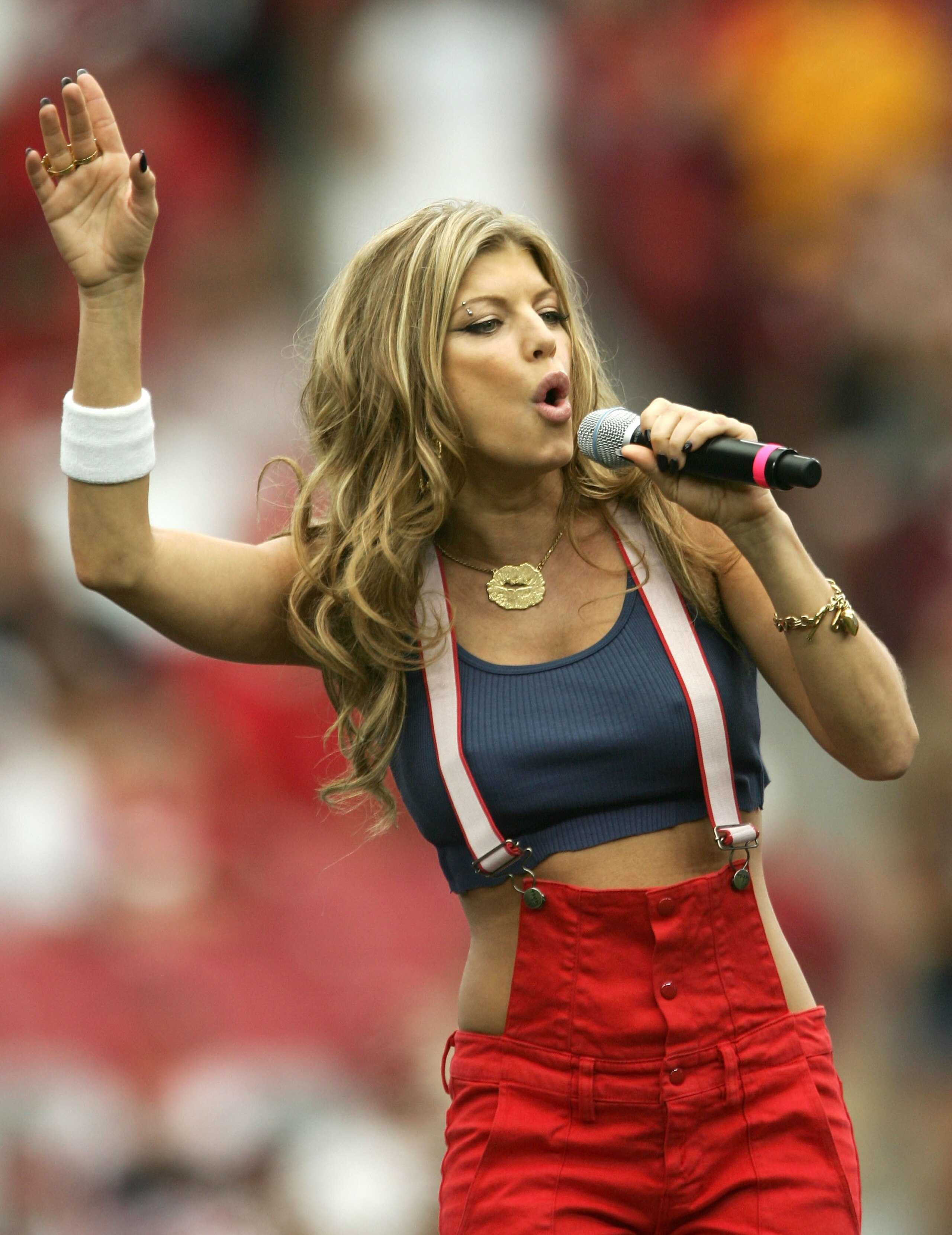 PHOENIX - SEPTEMBER 10:  Fergie of the Black Eyed Peas sings in the pre-game show before the game against the San Francisco 49ers and the Arizona Cardinals during the season opening game at Cardinals Stadium on September 10, 2006 in Phoenix, Arizona.  (Ph