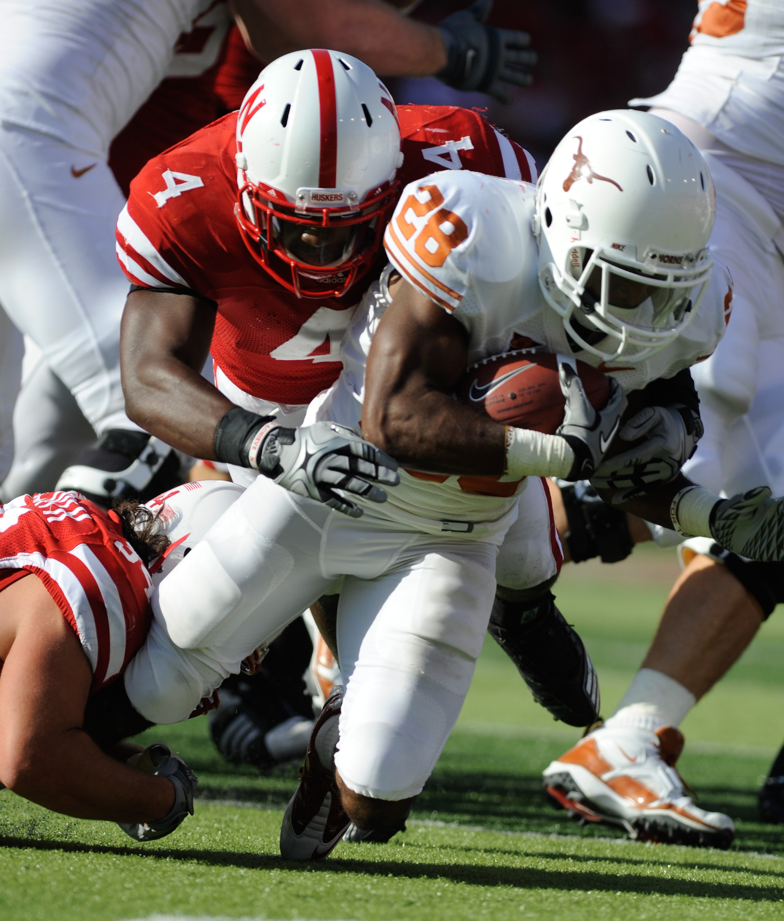 LINCOLN, NE - OCTOBER 16: Running back Foswhitt Whittaker #28 of the Texas Longhorns is brought down by linebacker Lavonte David #4 and defensive tackle Jared Crick #94 of the  Nebraska Cornhuskers during first half action of their game at Memorial Stadiu