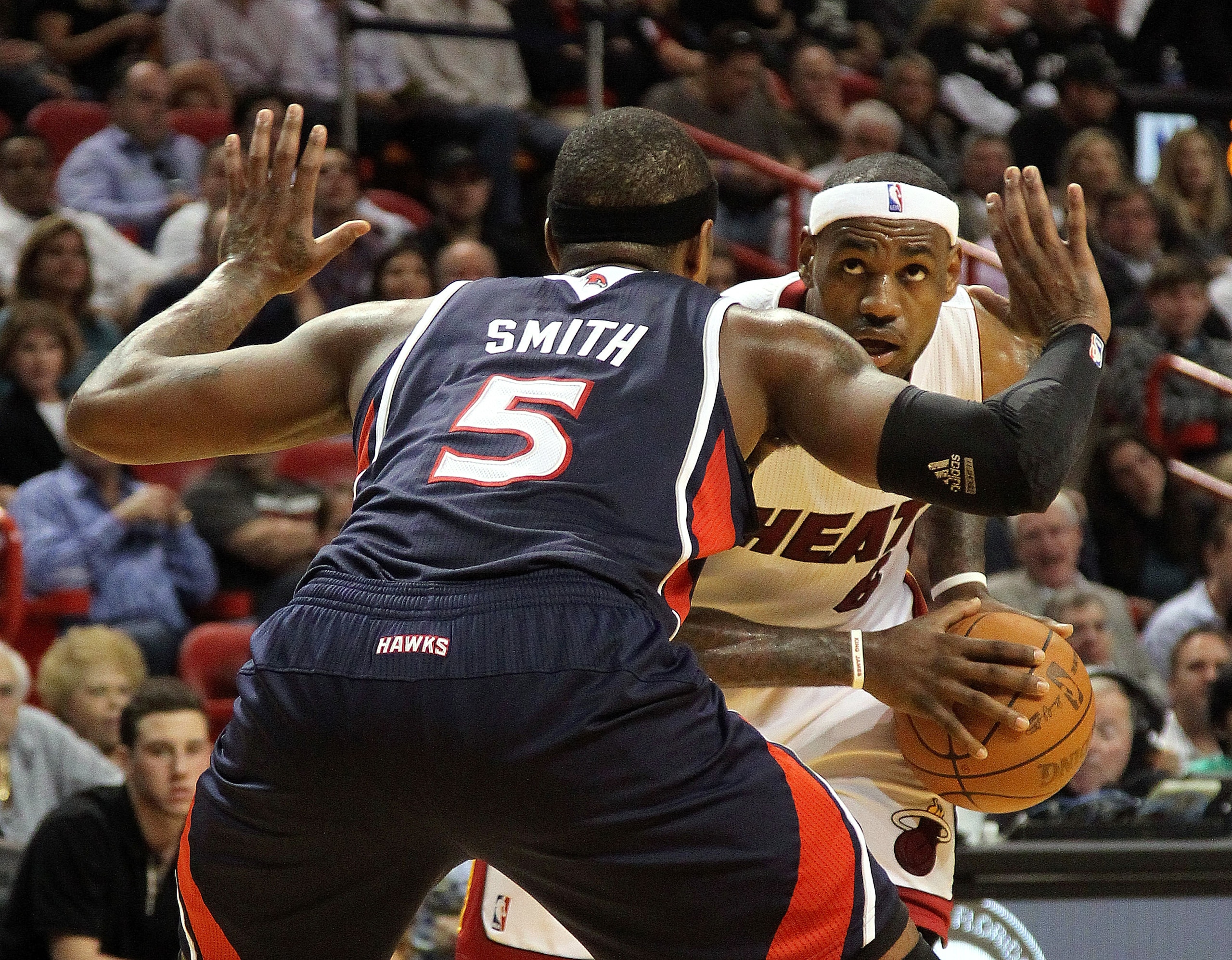 MIAMI, FL - JANUARY 18:  LeBron James #6 of the Miami Heat is guarded by Josh Smith #5 of the Atlanta Hawks during a game at American Airlines Arena on January 18, 2011 in Miami, Florida. NOTE TO USER: User expressly acknowledges and agrees that, by downl