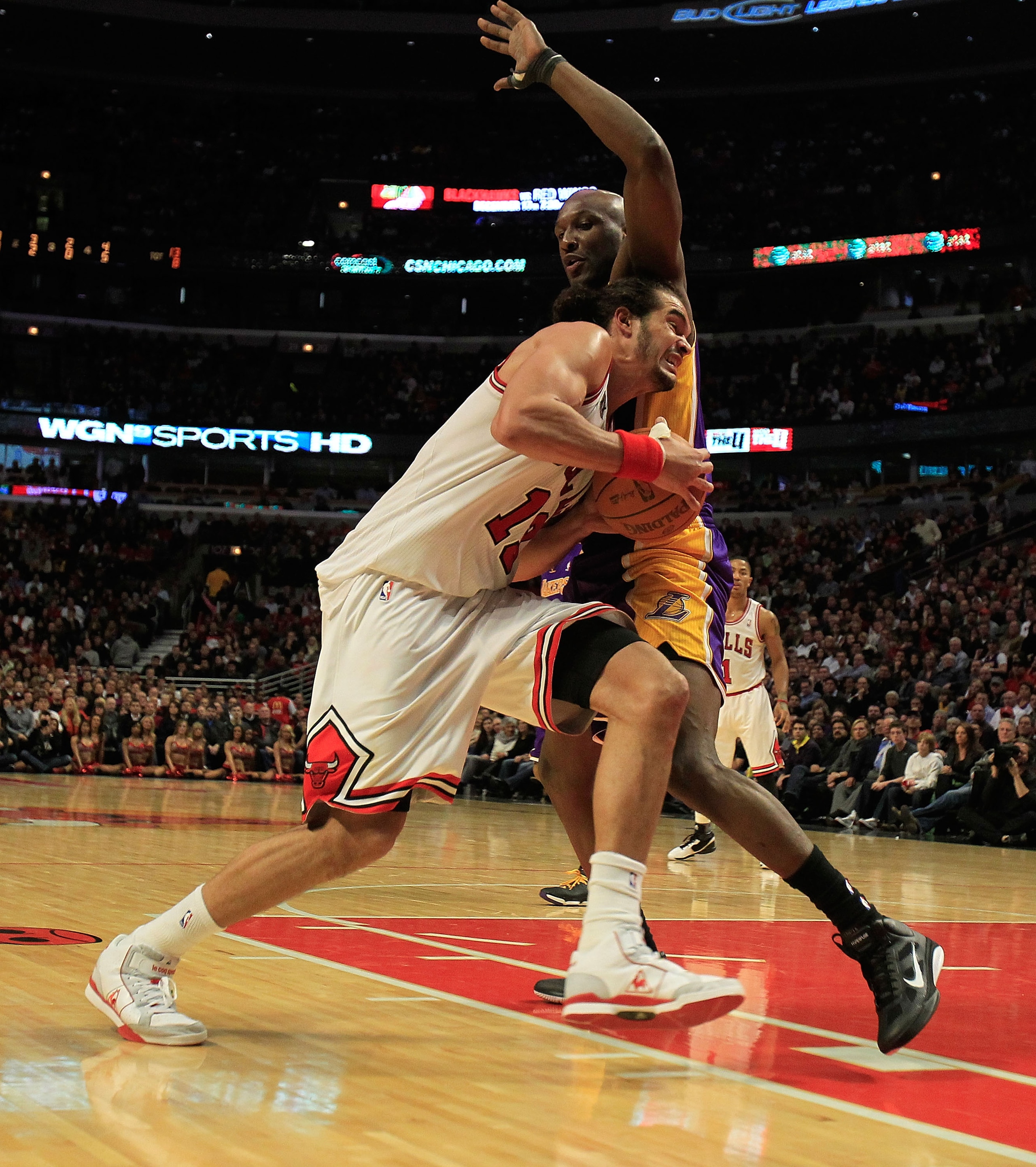 CHICAGO, IL - DECEMBER 10: Joakim Noah #13 of the Chicago Bulls drives against Lamar Odom #7 of the Los Angeles Lakers at the United Center on December 10, 2010 in Chicago, Illinois. The Bulls defeated the Lakers 88-84. NOTE TO USER: User expressly acknow