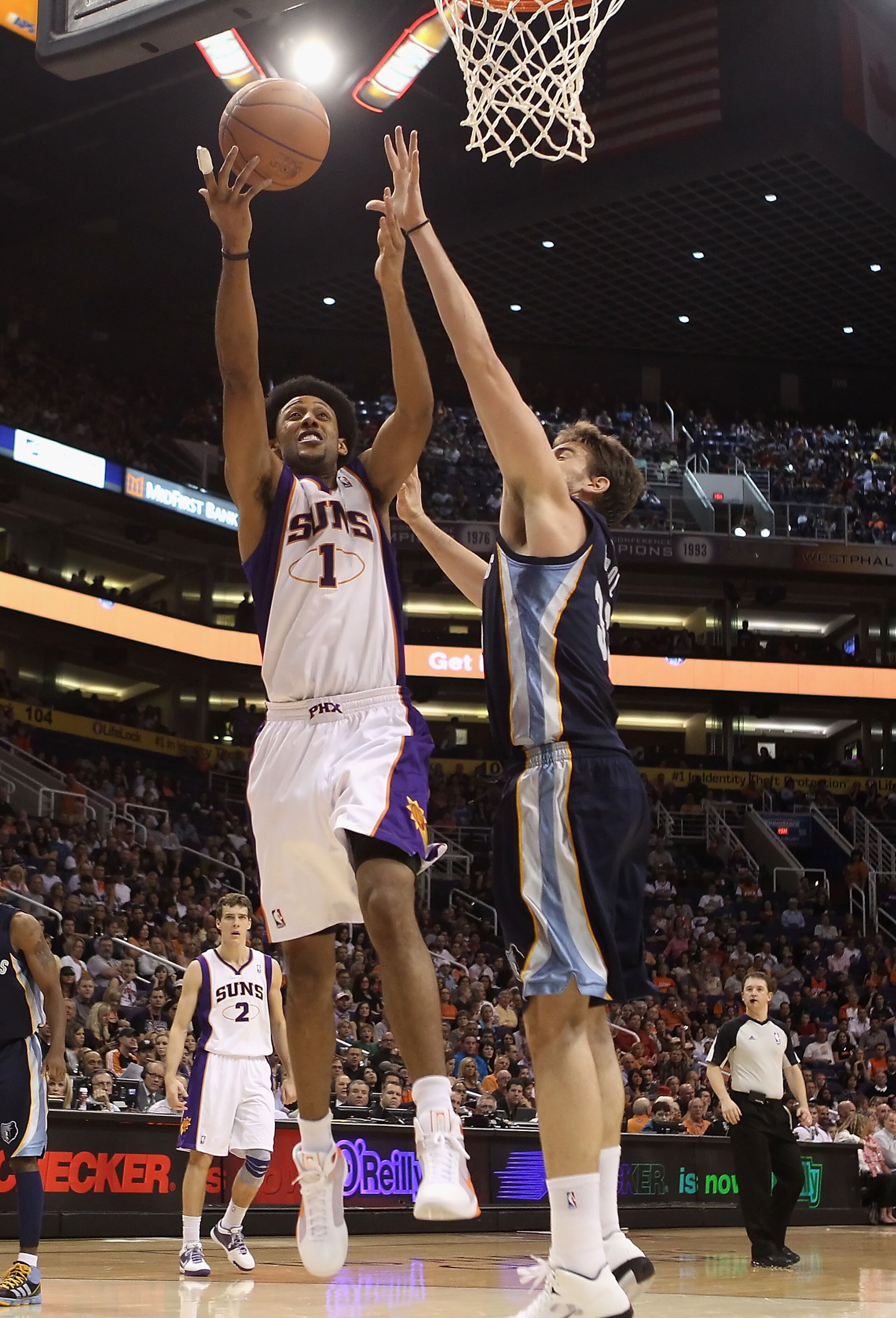 PHOENIX - NOVEMBER 05:  Josh Childress #1 of the Phoenix Suns lays up a shot past Marc Gasol #33 of the Memphis Grizzlies during the NBA game at US Airways Center on November 5, 2010 in Phoenix, Arizona. NOTE TO USER: User expressly acknowledges and agree