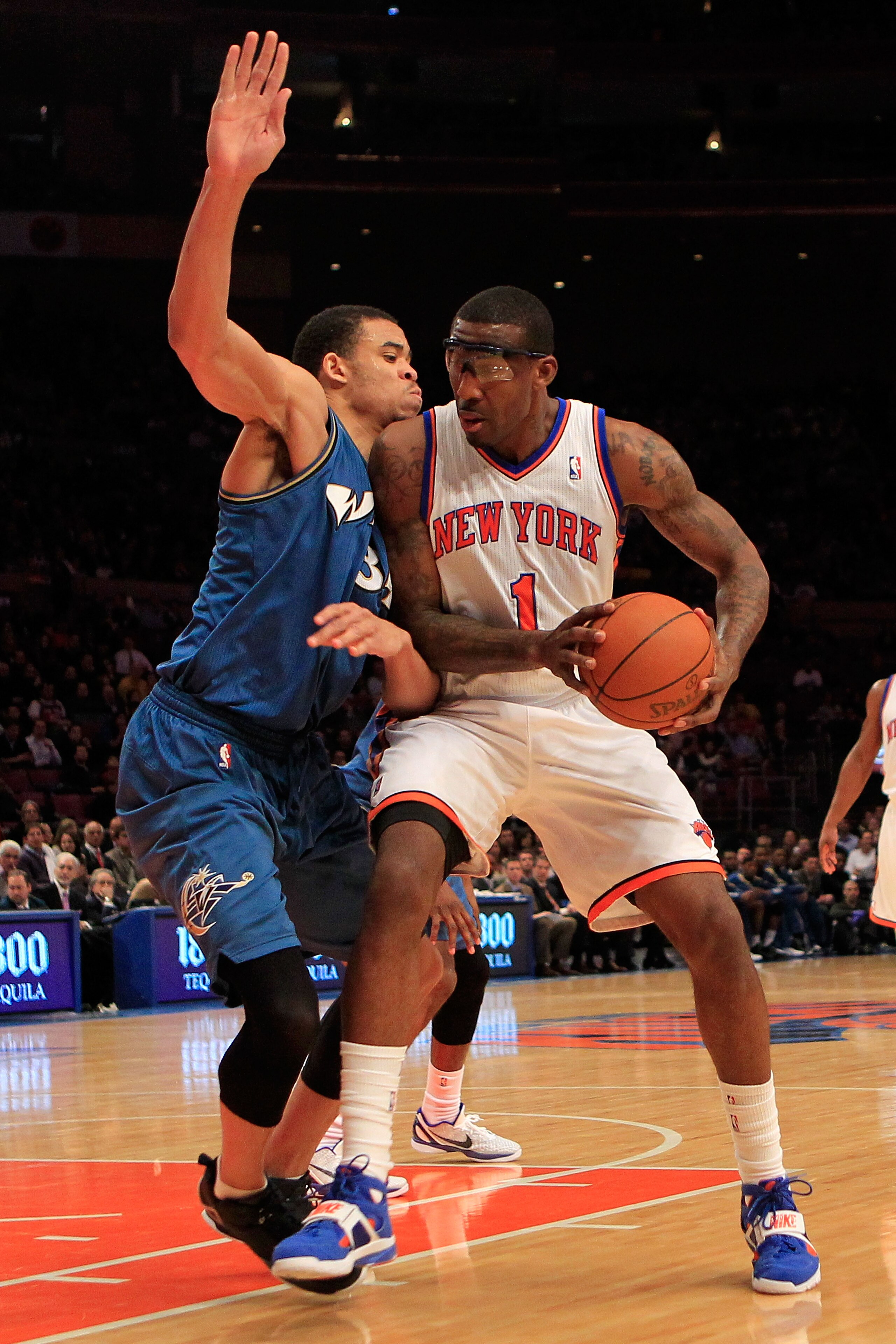 NEW YORK, NY - JANUARY 24:  Amar'e Stoudemire #1 of the New York Knicks drives past JaVale McGee #34 of the Washington Wizards at Madison Square Garden on January 24, 2011 in New York City. NOTE TO USER: User expressly acknowledges and agrees that, by dow