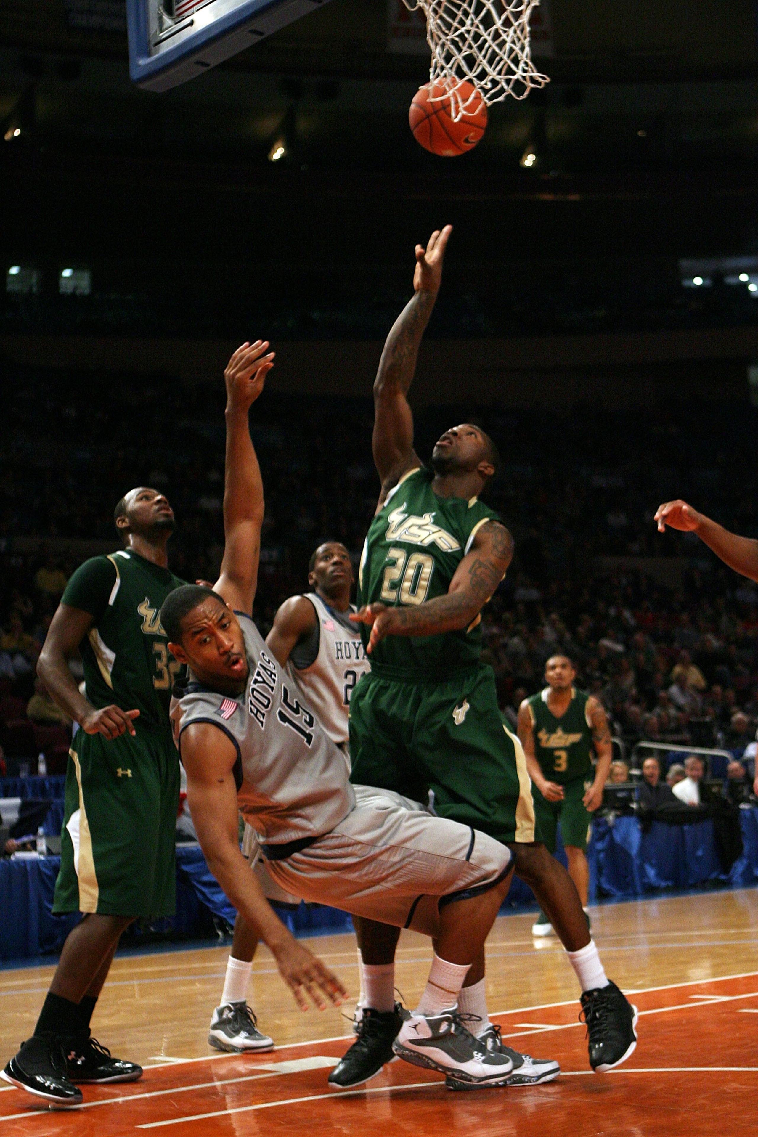 NEW YORK - MARCH 10:  Austin Freeman #15 of the Georgetown Hoyas draws contact against Dominique Jones #20 of the USF Bulls during the second round of 2010 NCAA Big East Tournament at Madison Square Garden on March 10, 2010 in New York City.  (Photo by Ch