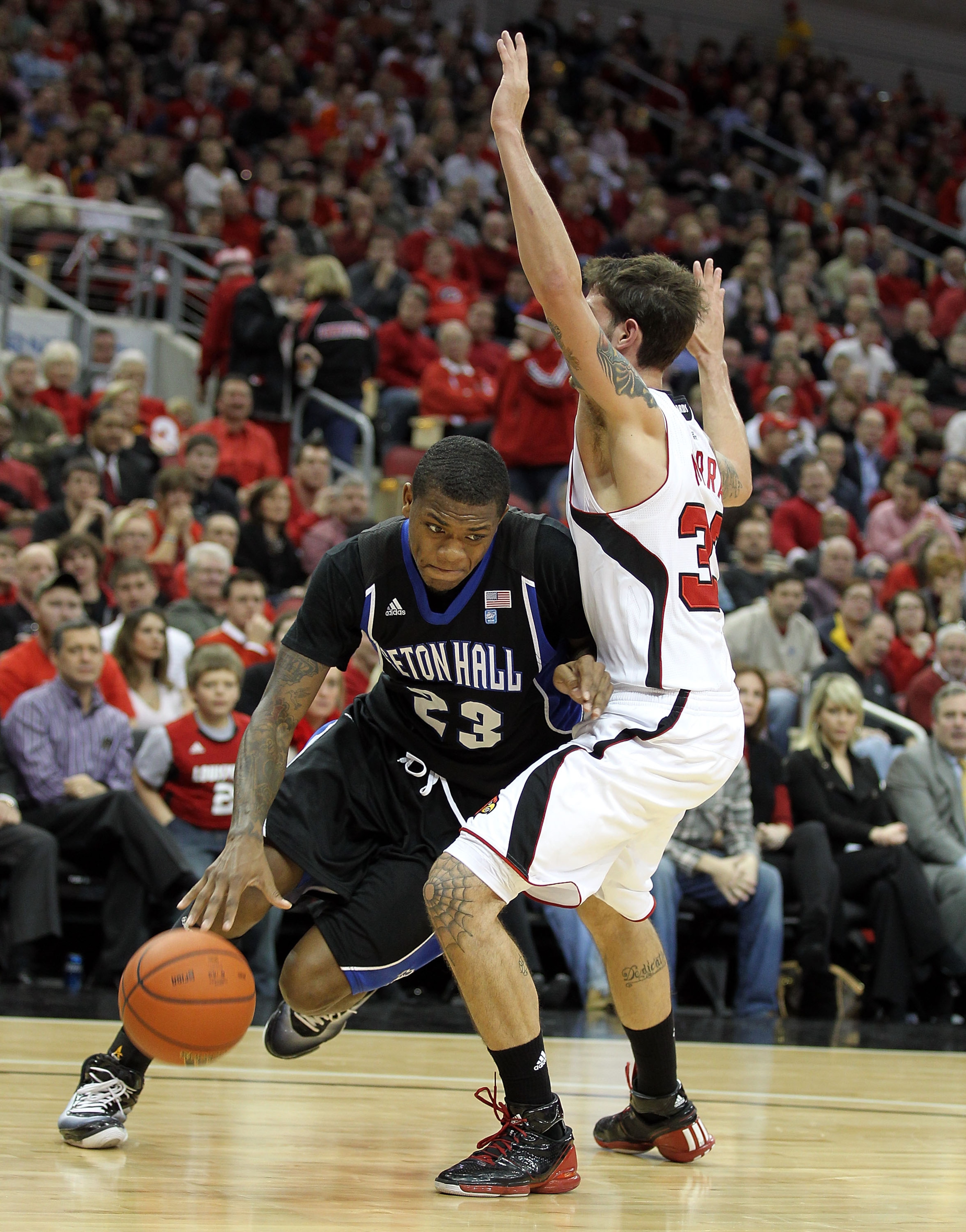 LOUISVILLE, KY - JANUARY 05: Fuquan Edwin #23 of the Seton Hall Pirates dribbles the ball while defended by Mike Marra #33 of the Louisville Cardinals during the Big East Conference game at the KFC Yum! Center on January 5, 2011 in Louisville, Kentucky. LOUISVILLE, KY - JANUARY 05: Fuquan Edwin #23 of the Seton Hall Pirates dribbles the ball while defended by Mike Marra #33 of the Louisville Cardinals during the Big East Conference game at the KFC Yum! Center on January 5, 2011 in Louisville, Kentucky.